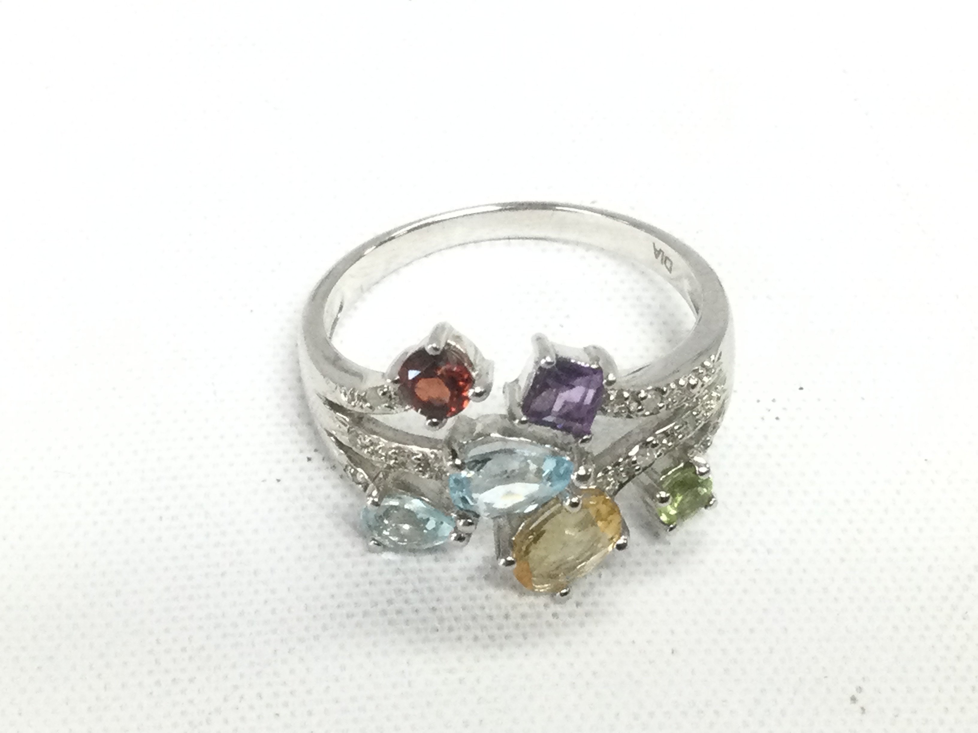 A 9ct white gold ring set with various coloured gemstones, approx 4.4g and approx size R. Shipping category A.