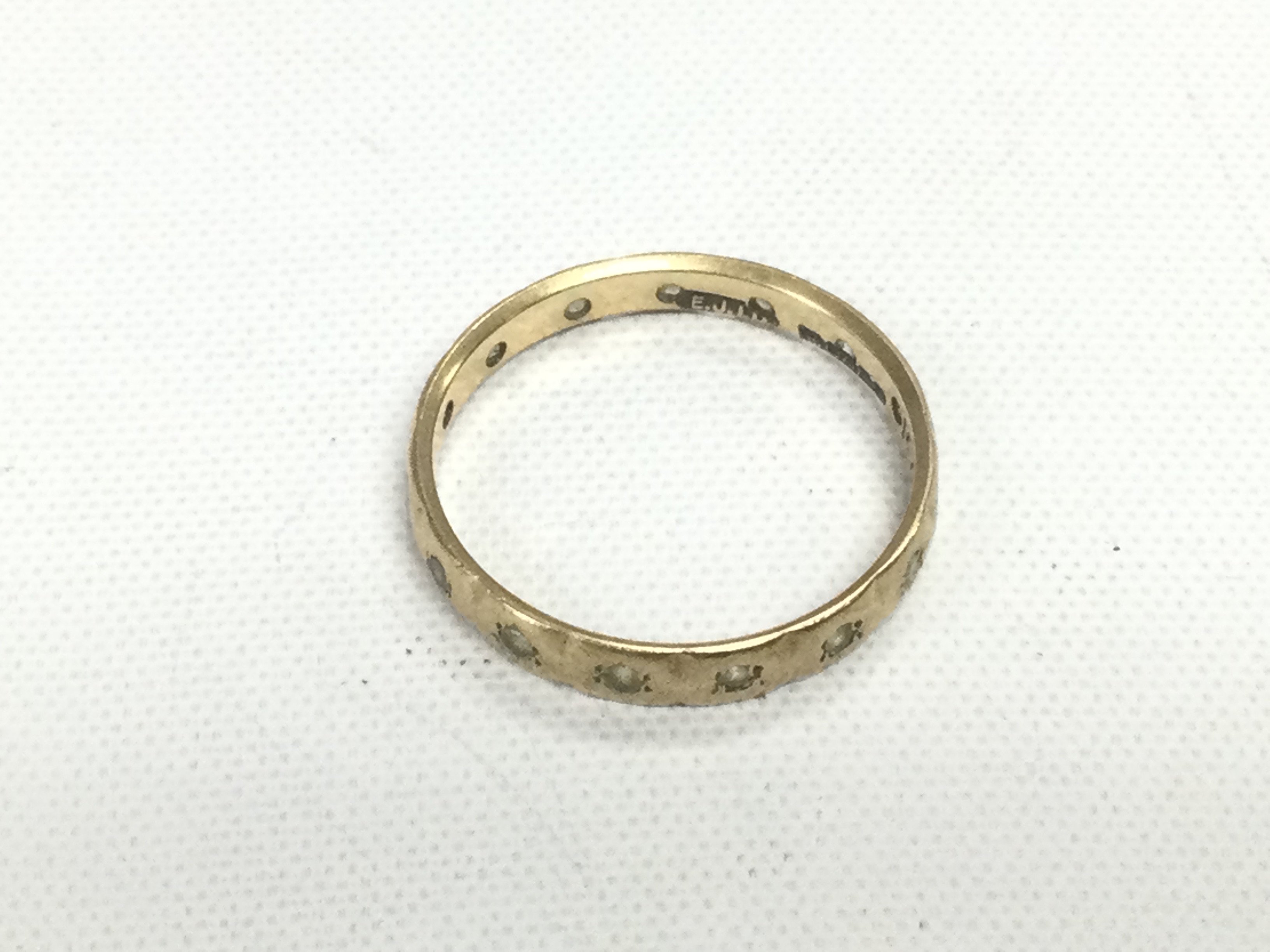 A 9ct gold ring set with stones, approx 1.4g and approx size N. Shipping category A.