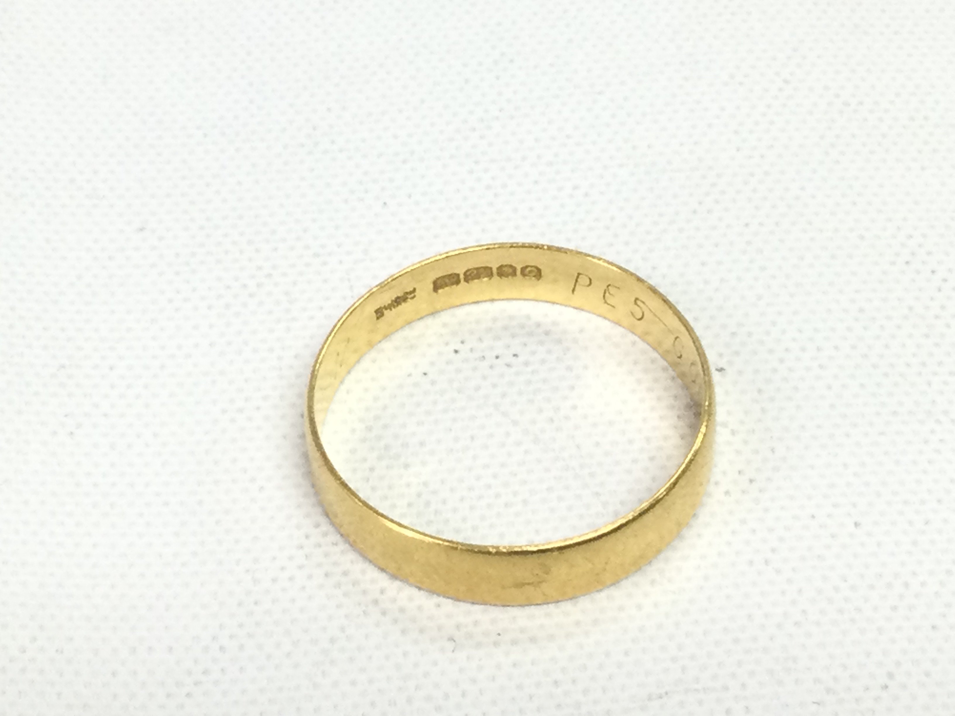 A 22ct gold wedding band, approx 2.2g and approx size M-N. Shipping category A.
