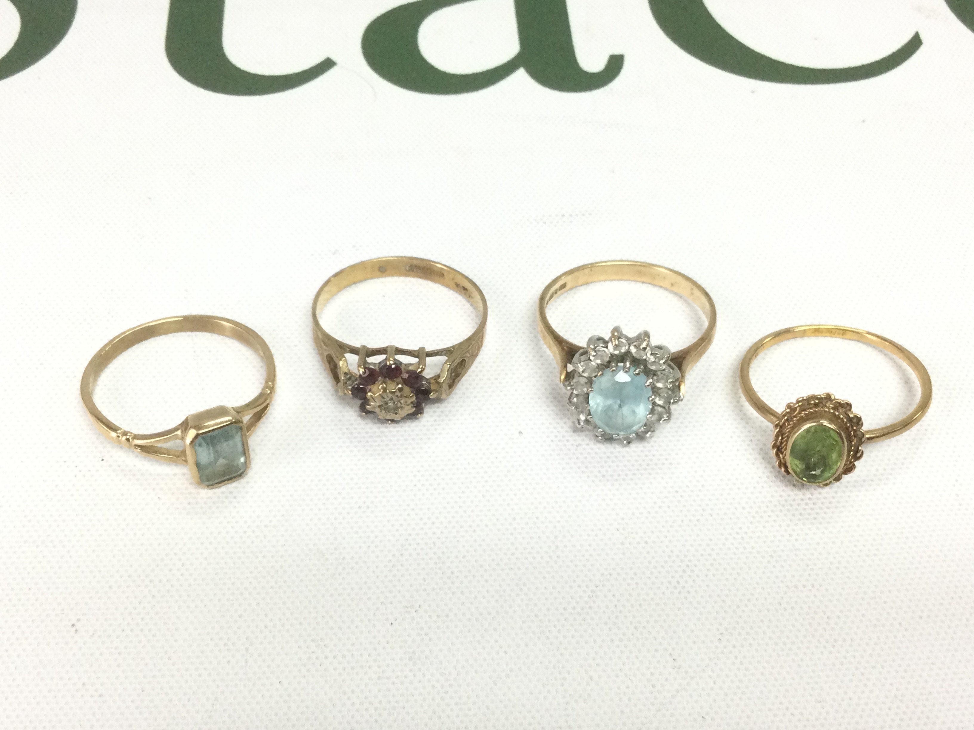 Four 9ct gold rings set with stones, total approx 8.8g. Shipping category A.