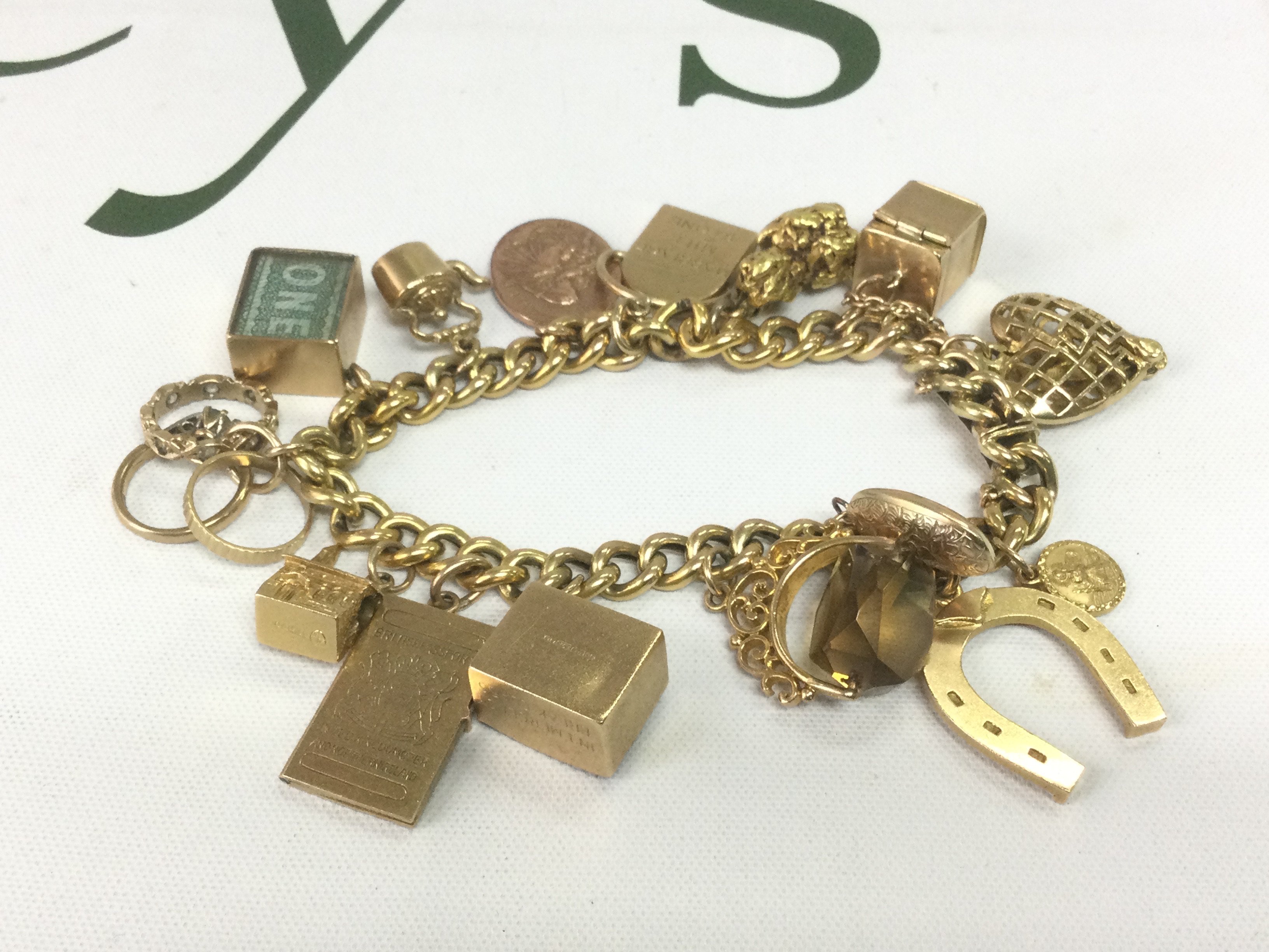 A heavy gold charm bracelet, approx 53.5g  Shipping category A.
