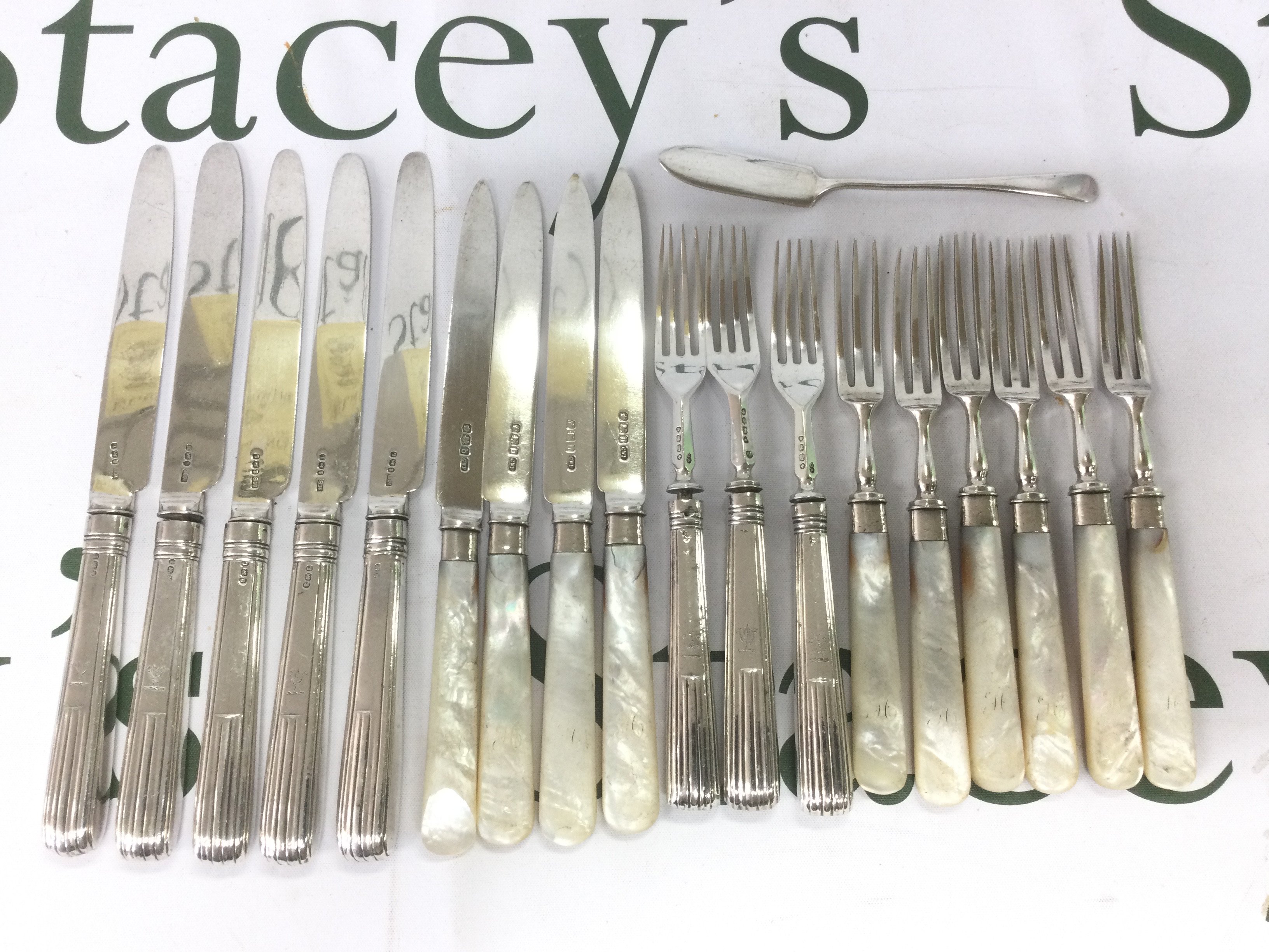 A collection of silver knives and forks. Shipping category B.