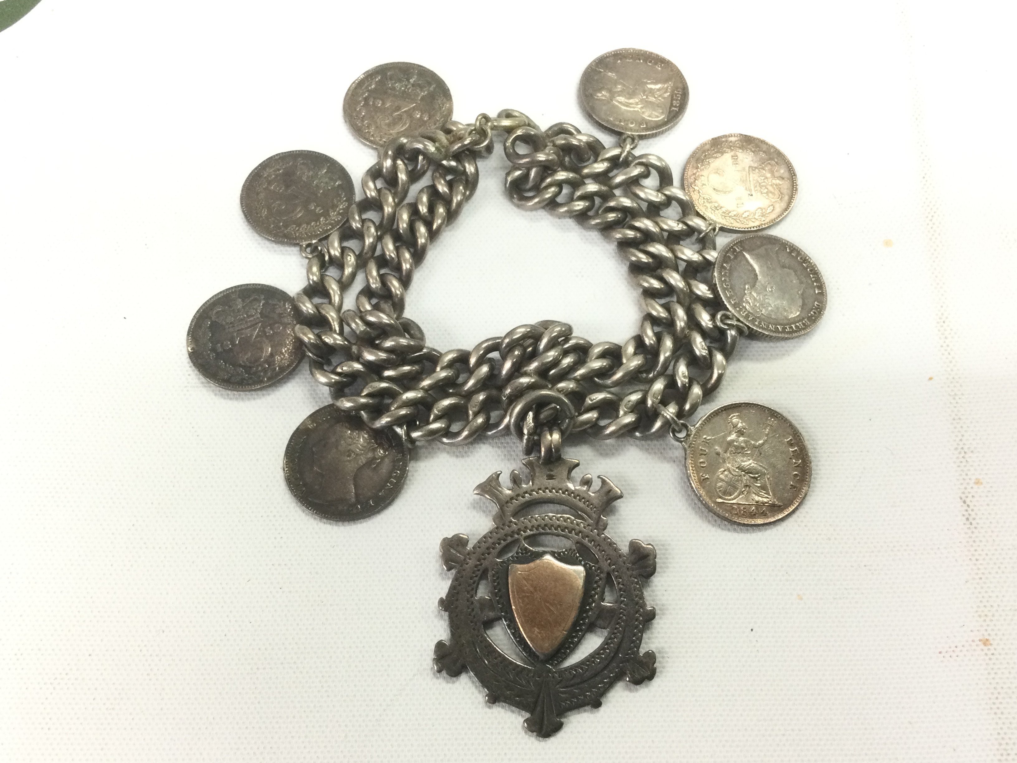 A silver charm bracelet. Shipping category A.