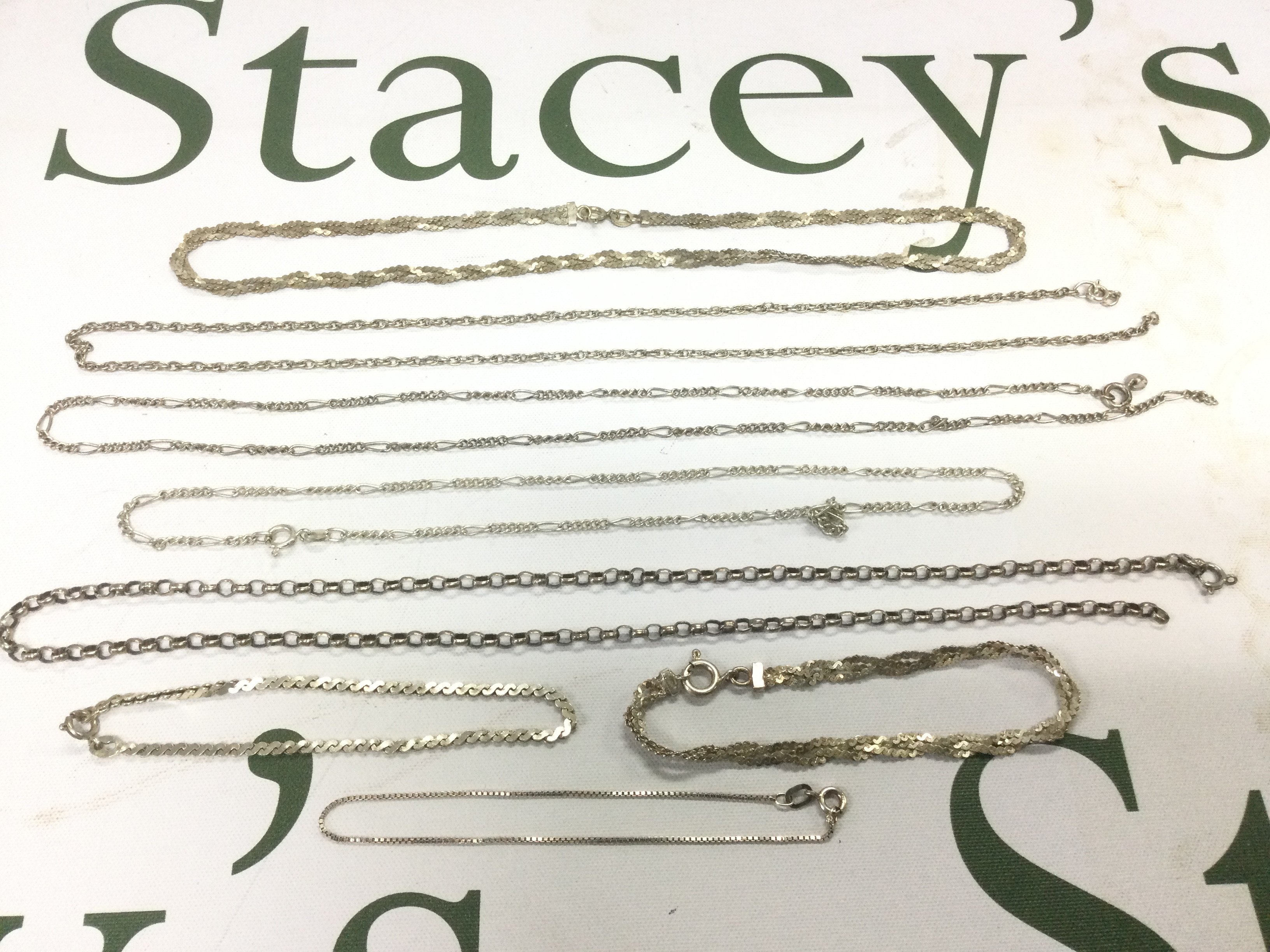 A collection of silver chains. Shipping category A.