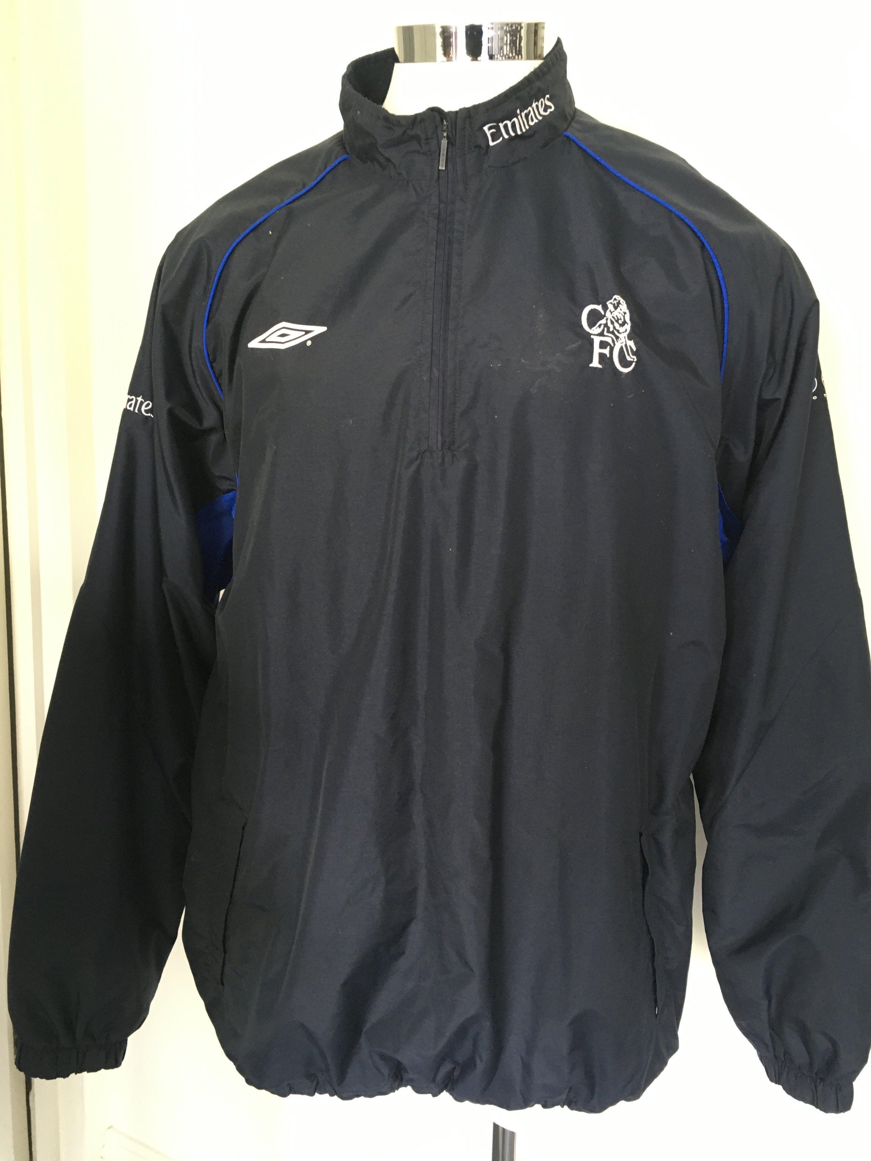 Frank Lampard Chelsea Player Issue Rain Jacket: Blue waterproof XXL Umbro Emirates zip up jacket. Very good with number 8 to the bottom of rear side. Used by Lampard in the early stages of his Chelsea playing career.