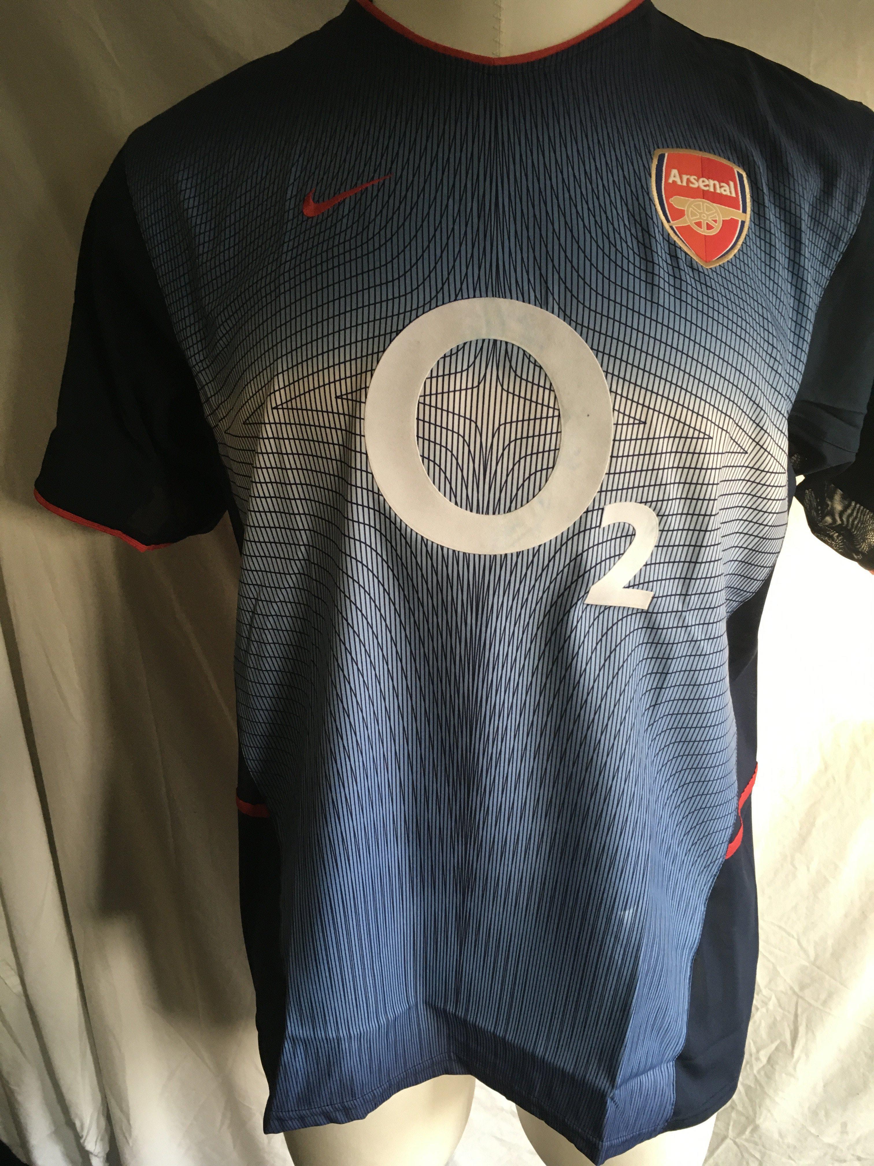 Thierry Henry Arsenal Match Worn Football Shirt: 2002/2003 blue short sleeve shirt with Champions League badging to right arm and 14 Henry to rear. C/W signed card by Henry stating I wore this shirt v Roma on 27 11 2002. Also 3 pictures of him wearing the shirt that evening. Please note only a few pieces of the annoying inner mesh are left as it was common for players to cut it out.