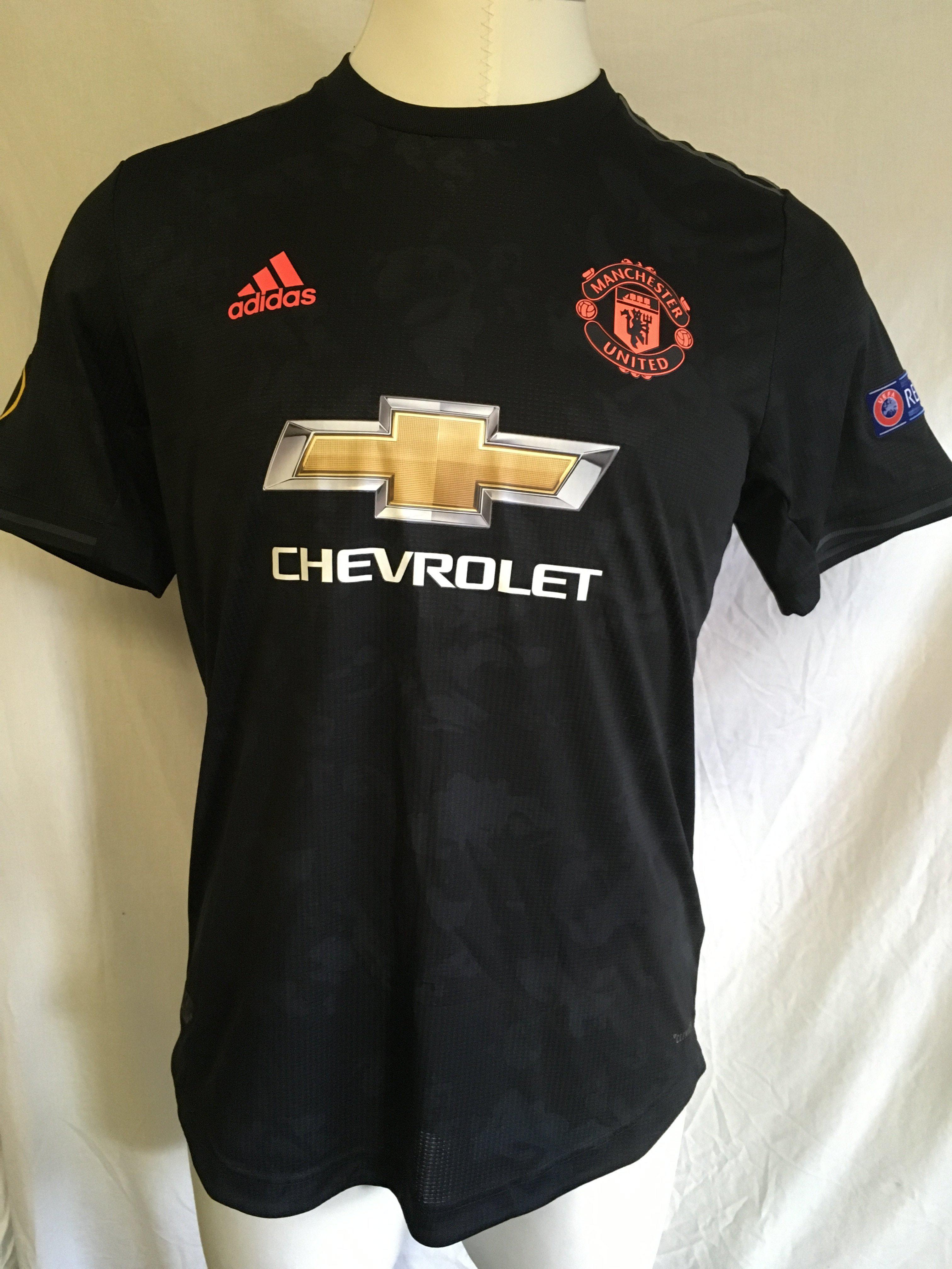 2019/2020 Manchester United Champions League Match Worn Football Shirt: Hard to obtain black Chevrolet sponsored short sleeve shirt with Champions League badging to arms. bright orange number 20 Dalit to rear. Signed to back.