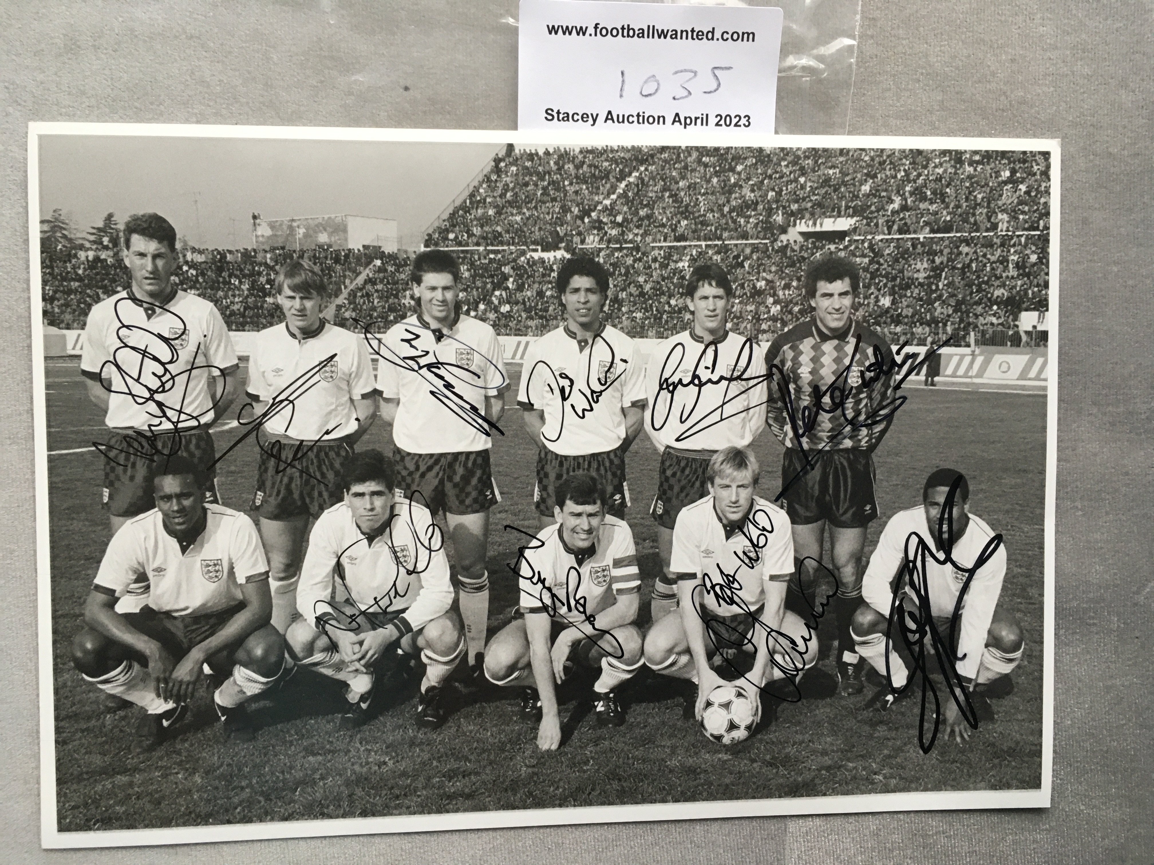 1989 + 1982 England Signed Football Photos: Collected by official photographer for the match away to Albania 1989 and the 9-0 win in Luxembourg 1982. Signed by 11 players on each including John Barnes, Gary Lineker, Bryan Robson and Terry Butcher to 1989 and Alvin Martin, Gary Mabbutt and Luther Blissett to 1982 photo. Press annotations to rear. (2)