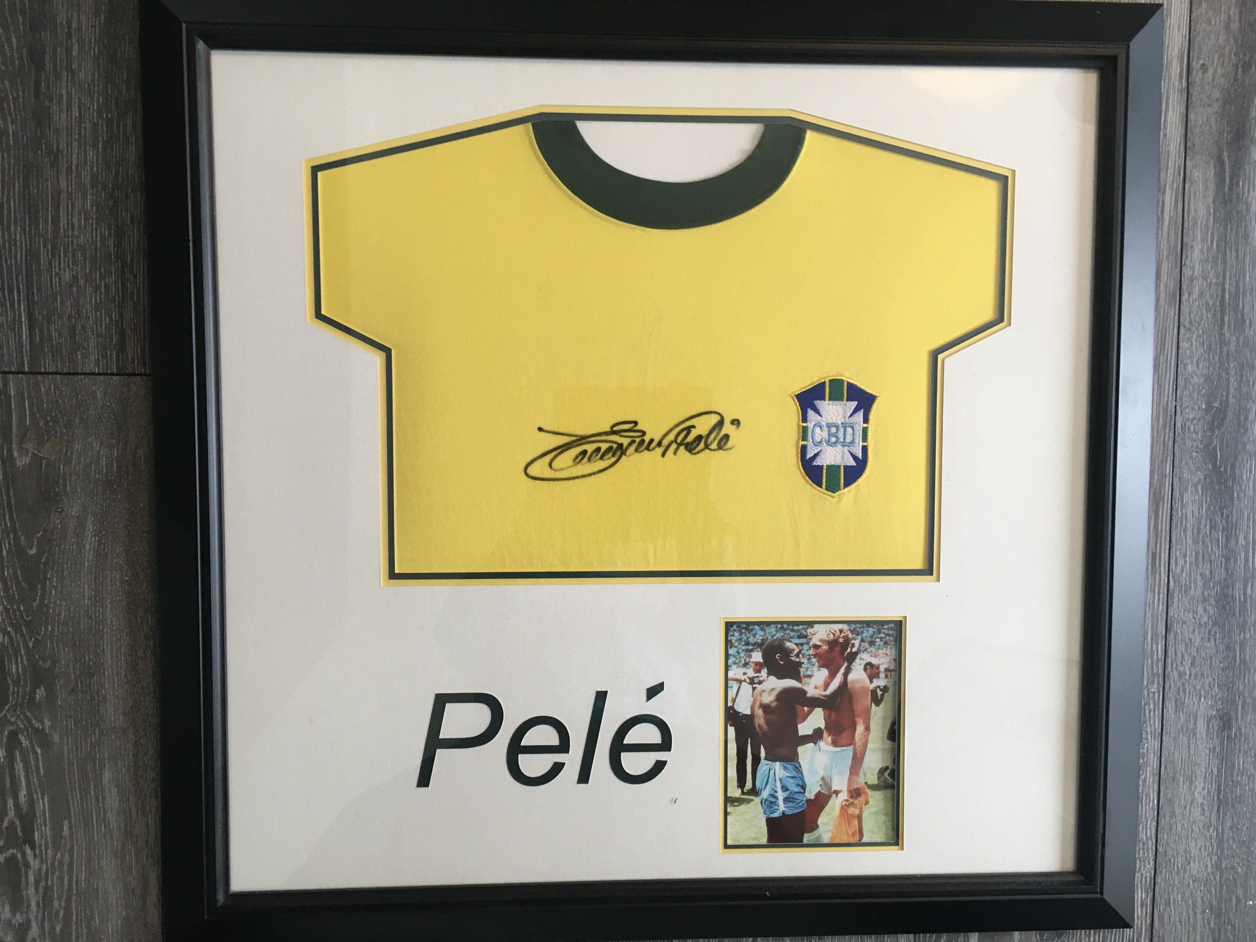 Pele Signed Framed Football Shirt: Quality genuine item signed on yellow Brazil shirt Edson Pele. Famous picture of him at the World Cup with Bobby Moore.