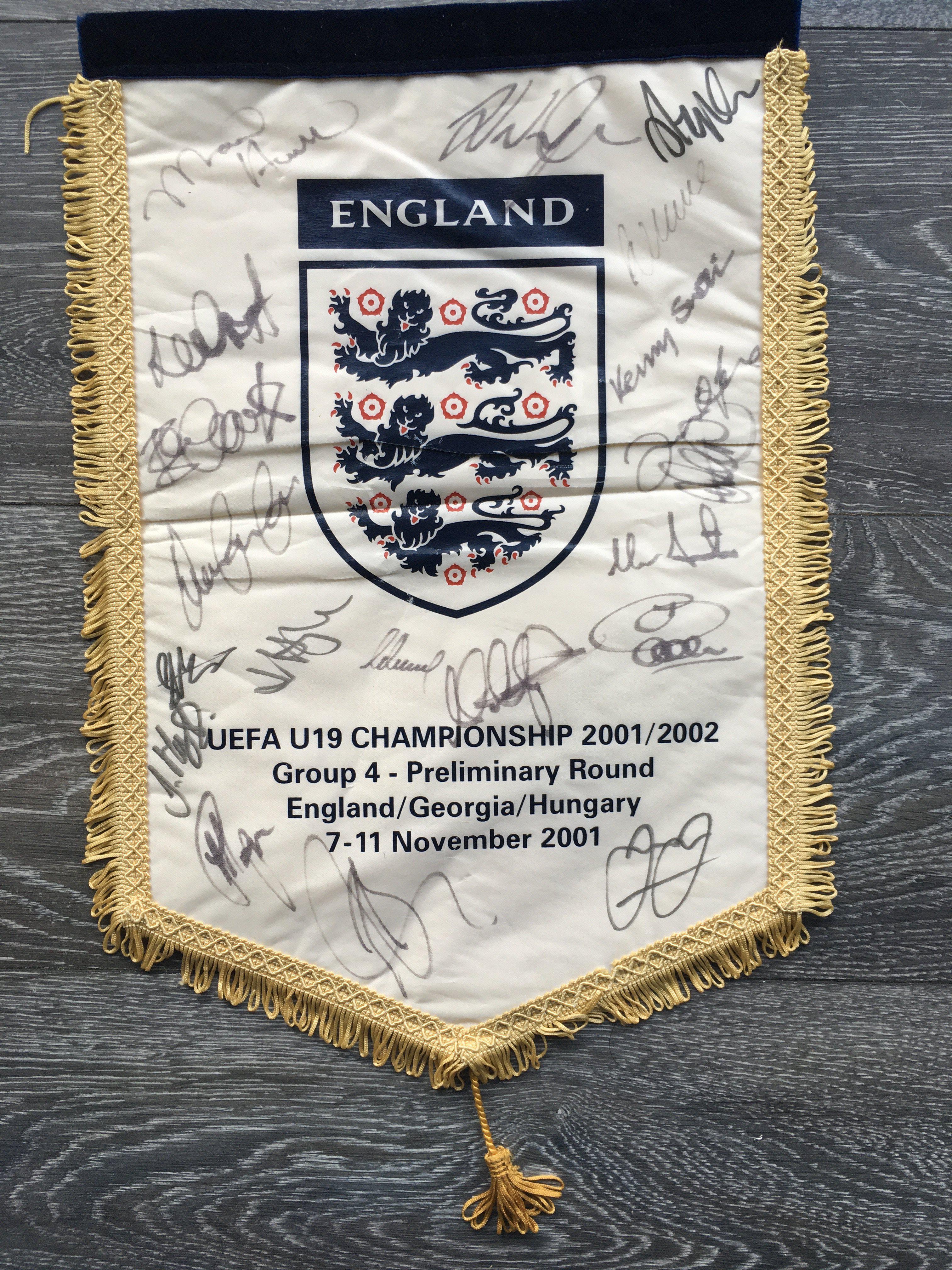 England 2001 Signed U19 Football Pennant: Official England pennant given to players and officials which states England, Georgia and Hungary from 7-11 November 2091. Hand signed by 19 of the England squad. Couple of marks to rear. This team had Dean Ashton, Jermaine Jenas and Glen Johnson.