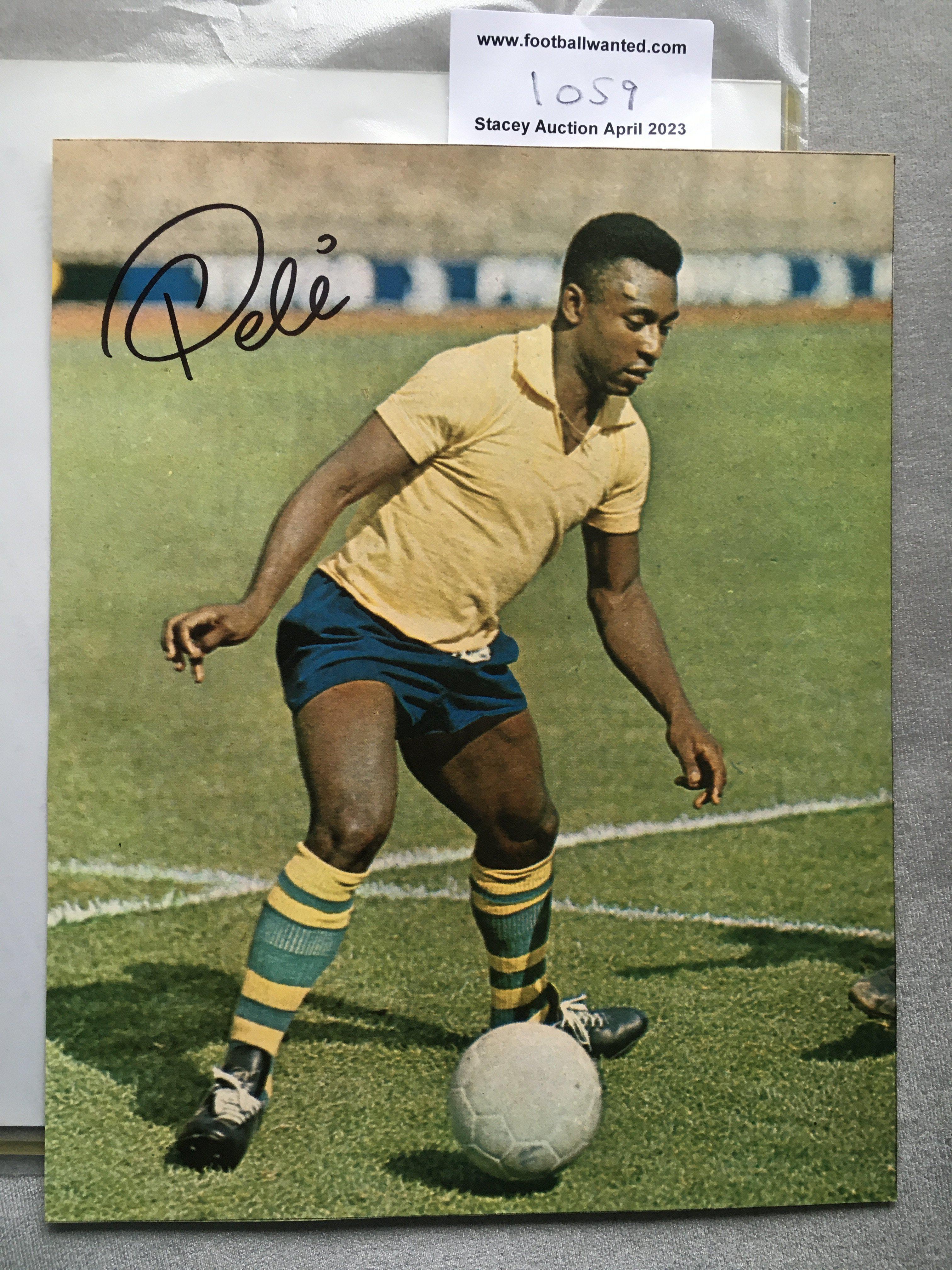 Pele Signed Brazil Football Picture: Large colour magazine picture of a young Pele hand signed in marker pen. C/W and unsigned picture of him with Bobby Moore.