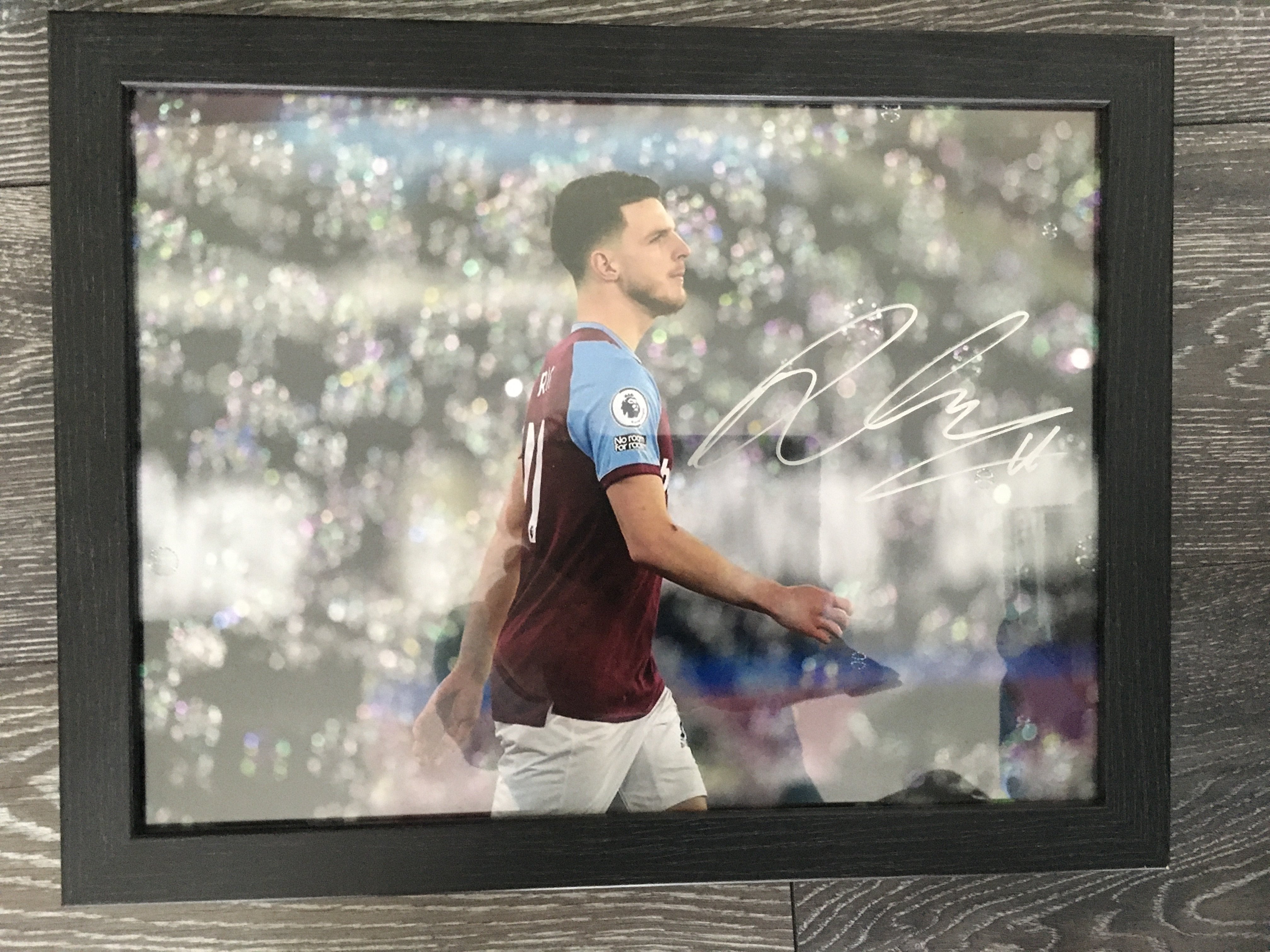 Declan Rice West Ham Signed Photo + Shirt: 2020 125 years shirt with Rice 41 to rear where he has signed. Large photo is framed and depicts Declan surrounded by bubbles at the London stadium. Clearly signed in silver marker. (2)