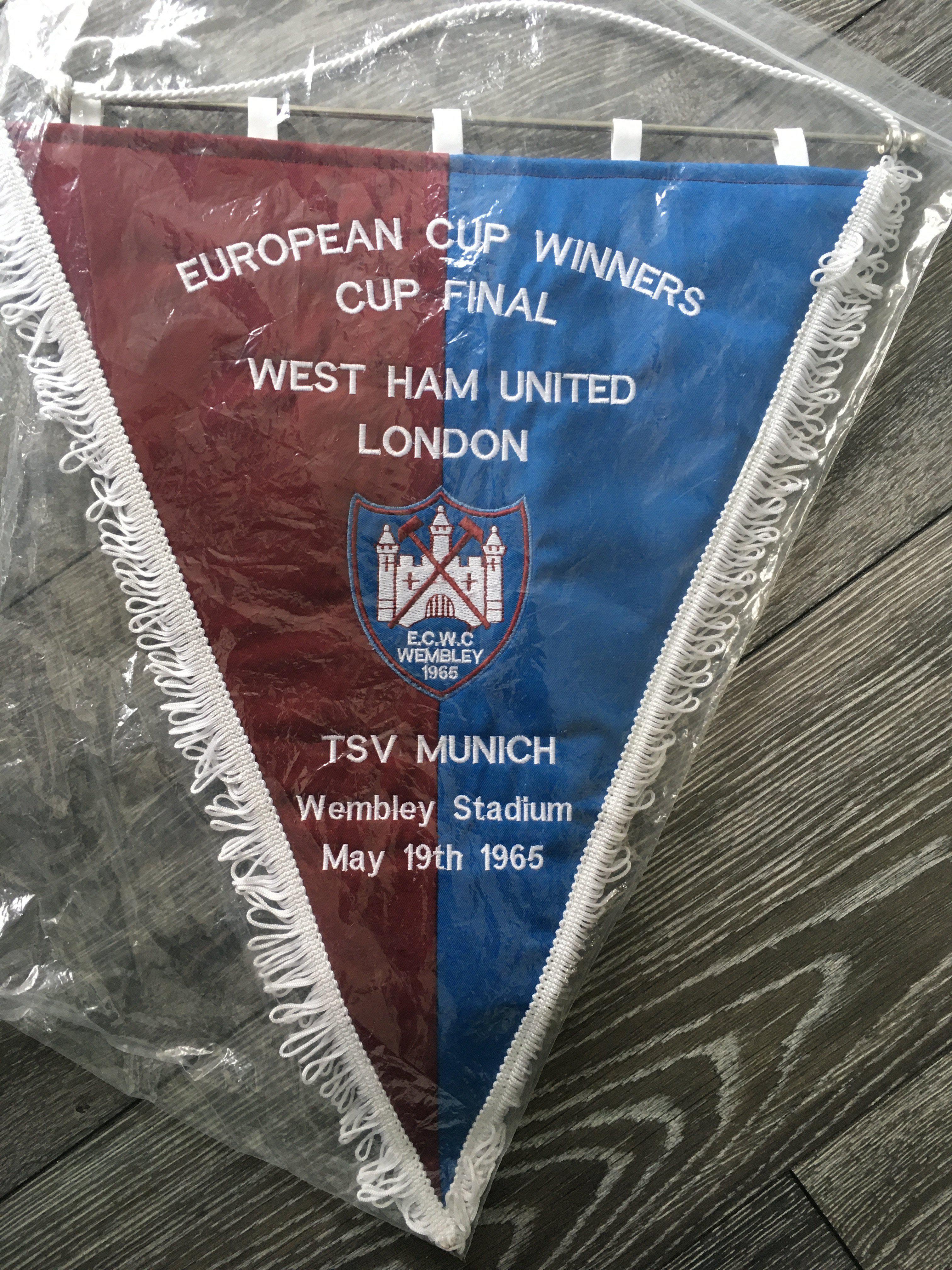 West Ham 1965 ECWC Final Pennant + Signed Shirt: Very large padded pennant with match details of the game v TSV Munich. C/W Toffs replica medium West Ham shirt signed by Hurst + Peters. (2)