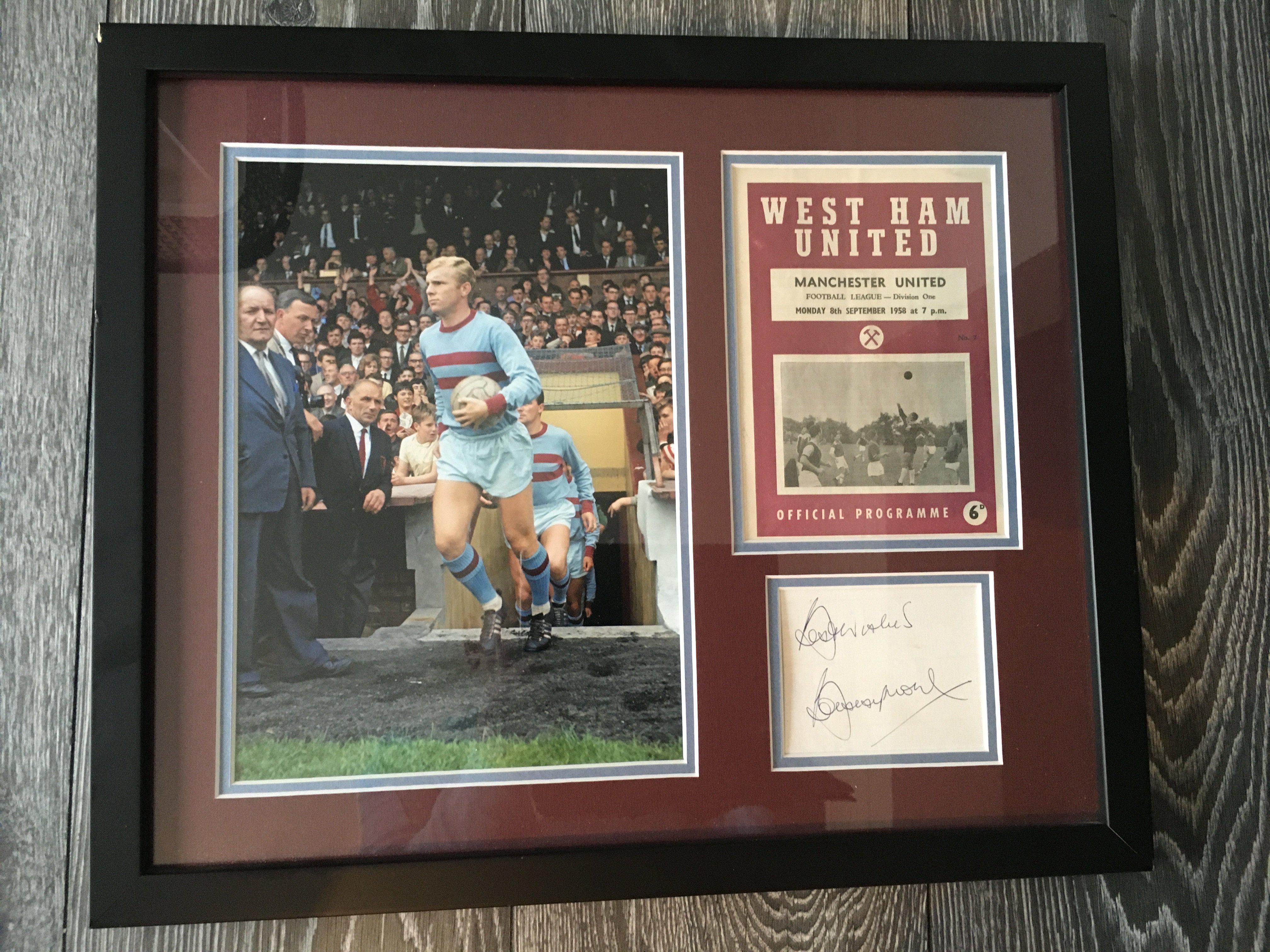 Bobby Moore West Ham Framed Signed Display: Stunning photo of Bobby coming out the tunnel in West Ham away kit with and original programme from his debut in 1958 and a large Best Wishes Bobby Moore on white card. Framed and mounted in claret and blue.