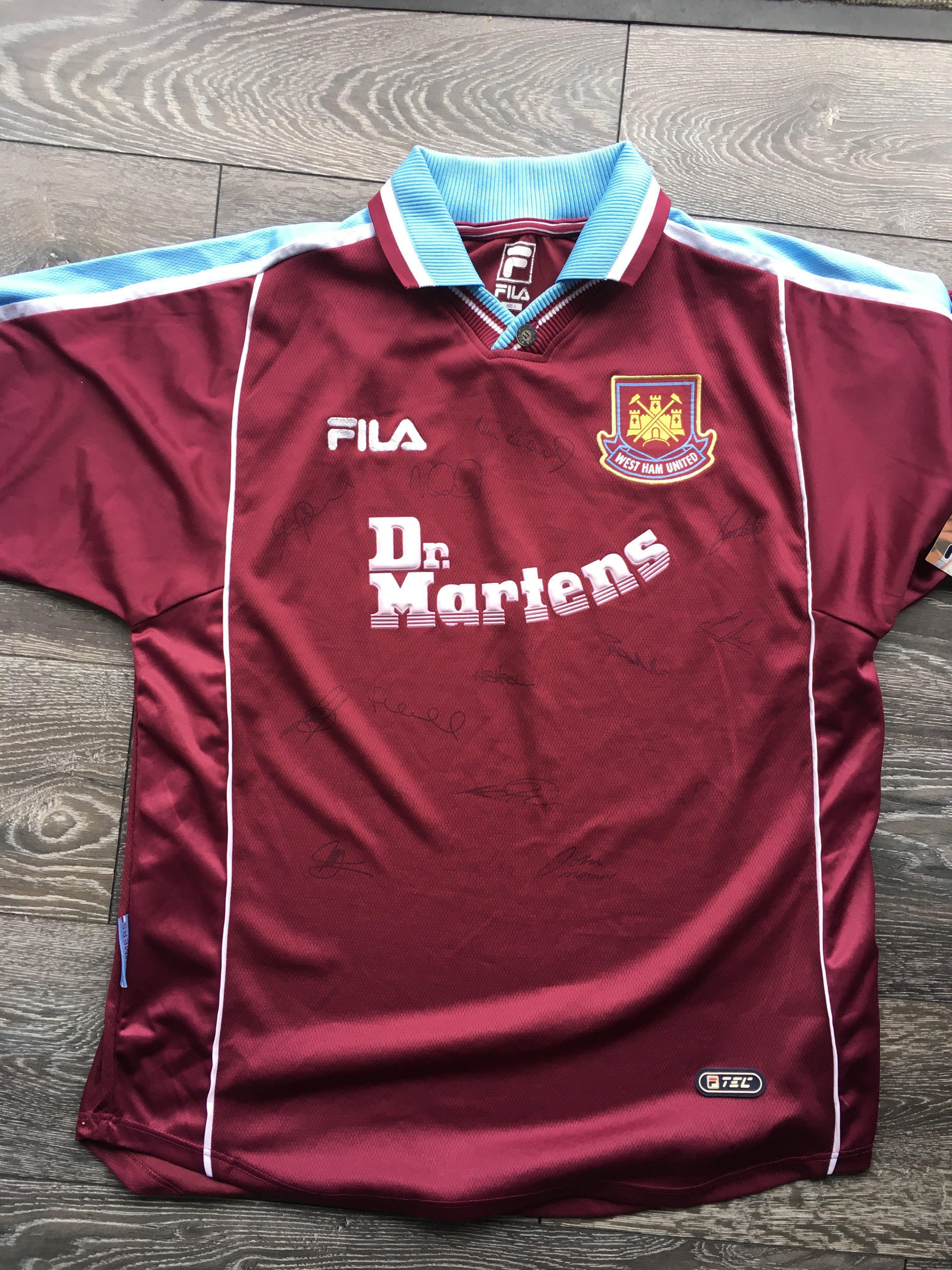 West Ham Signed Football Shirt: BNWT home Dr Martens shirt lightly signed by 13 including Lampard and Moncur. C/W some England + West Ham related t-shirts. (10)