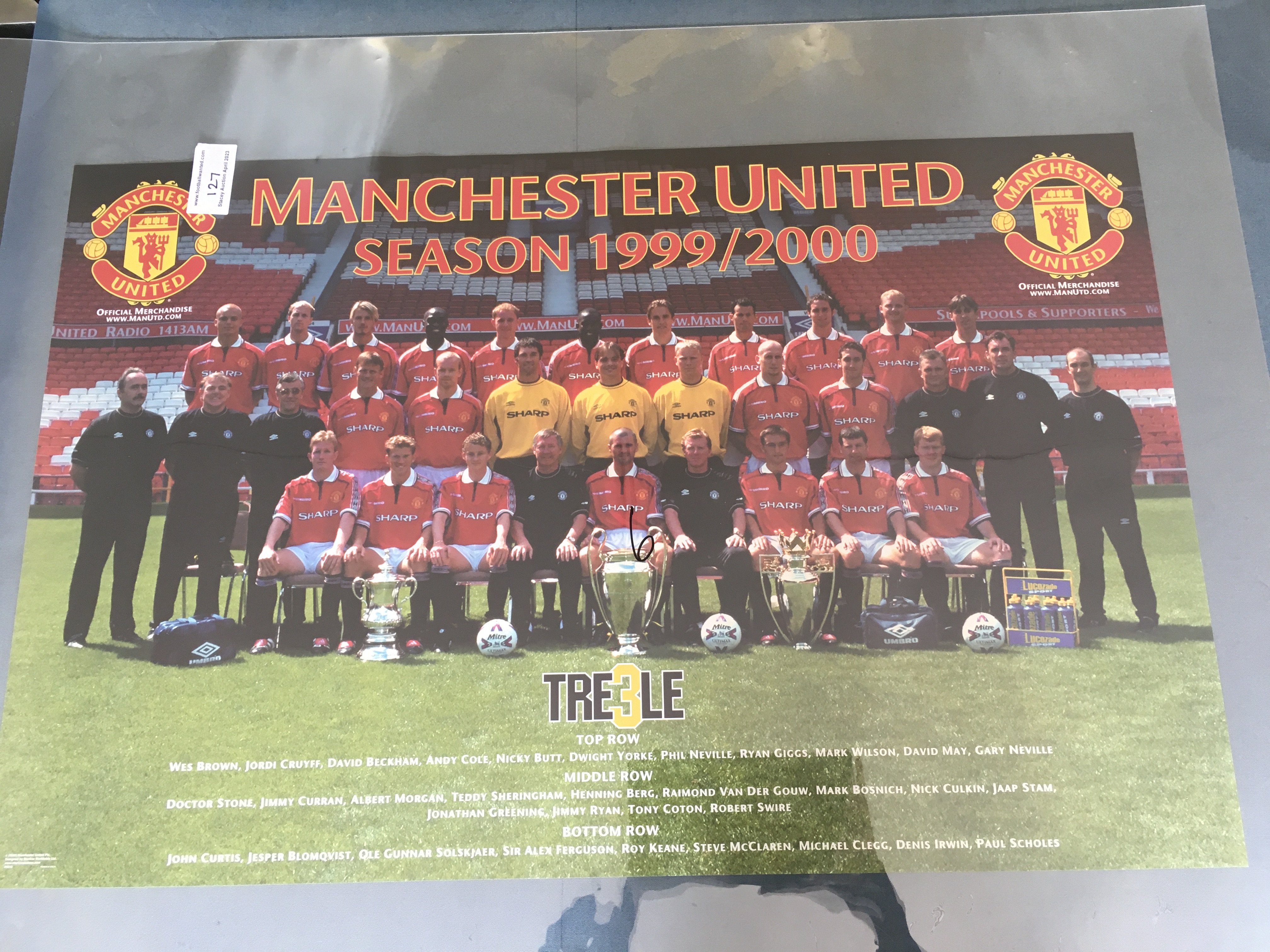 Manchester United Large Treble Team Football Poster: Mint condition poster in plastic cover measuring a massive 87 x 58cm. Depicts the squad with all 3 trophies in front of them before the 99/00 season.