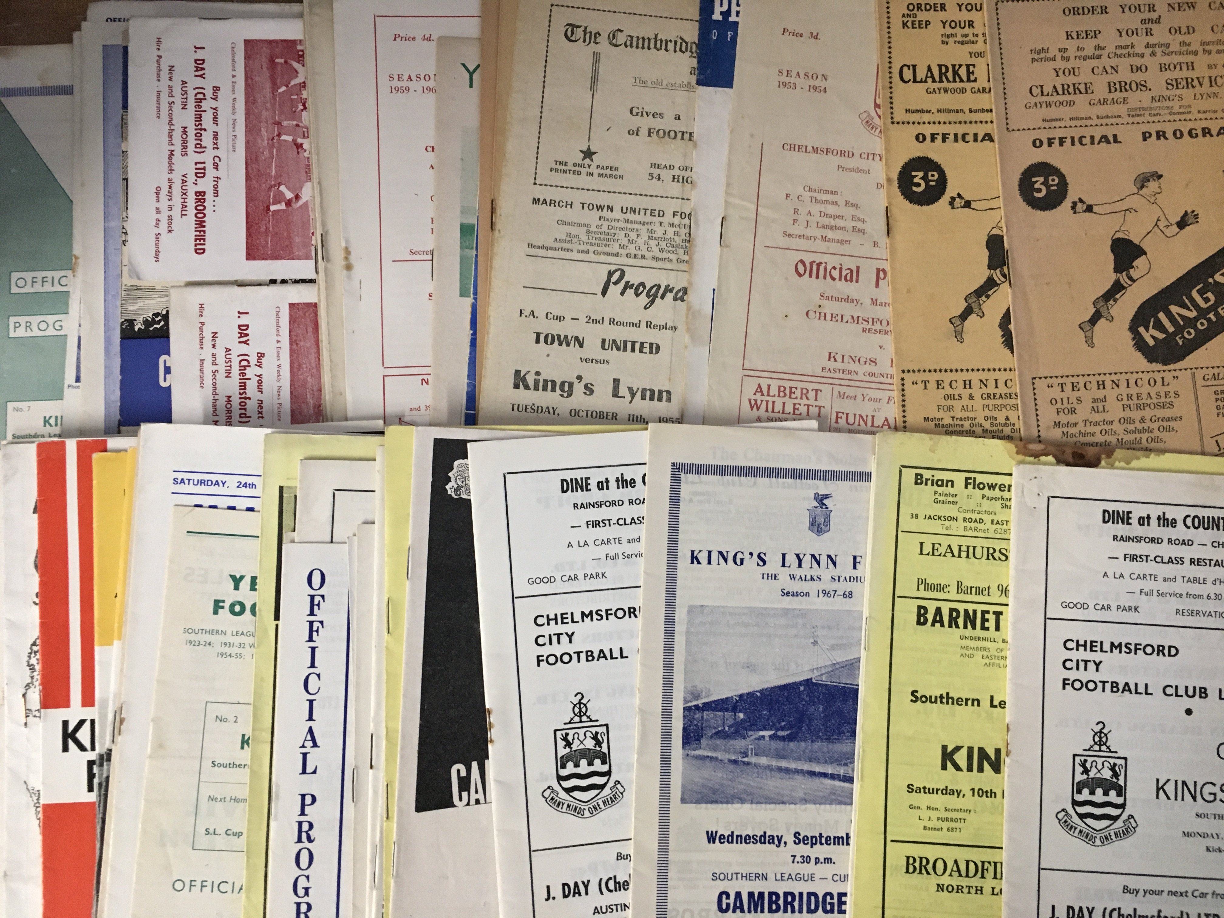 Kings Lynn Football Programmes: Over 50 mainly away programmes from the 60s and 70s with a few earlier. Quantity of team sheets then four very heavy boxes of modern home and away programmes. (5 boxes)