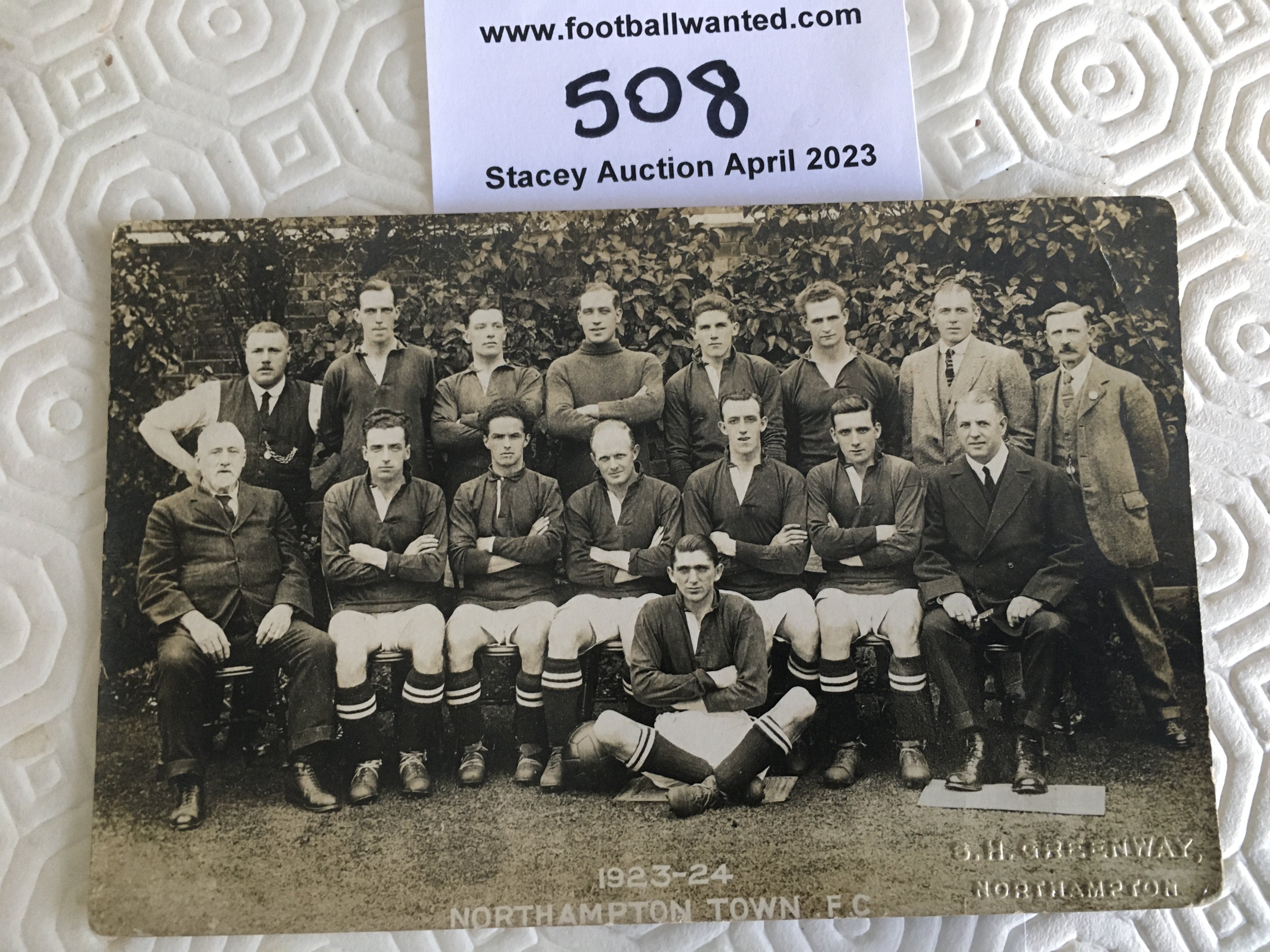 Northampton Town 1923 - 1924 Football Postcard: Good condition team group with unwritten postcard rear. Tiny crease in corner. Embossed and produced by Greenway.