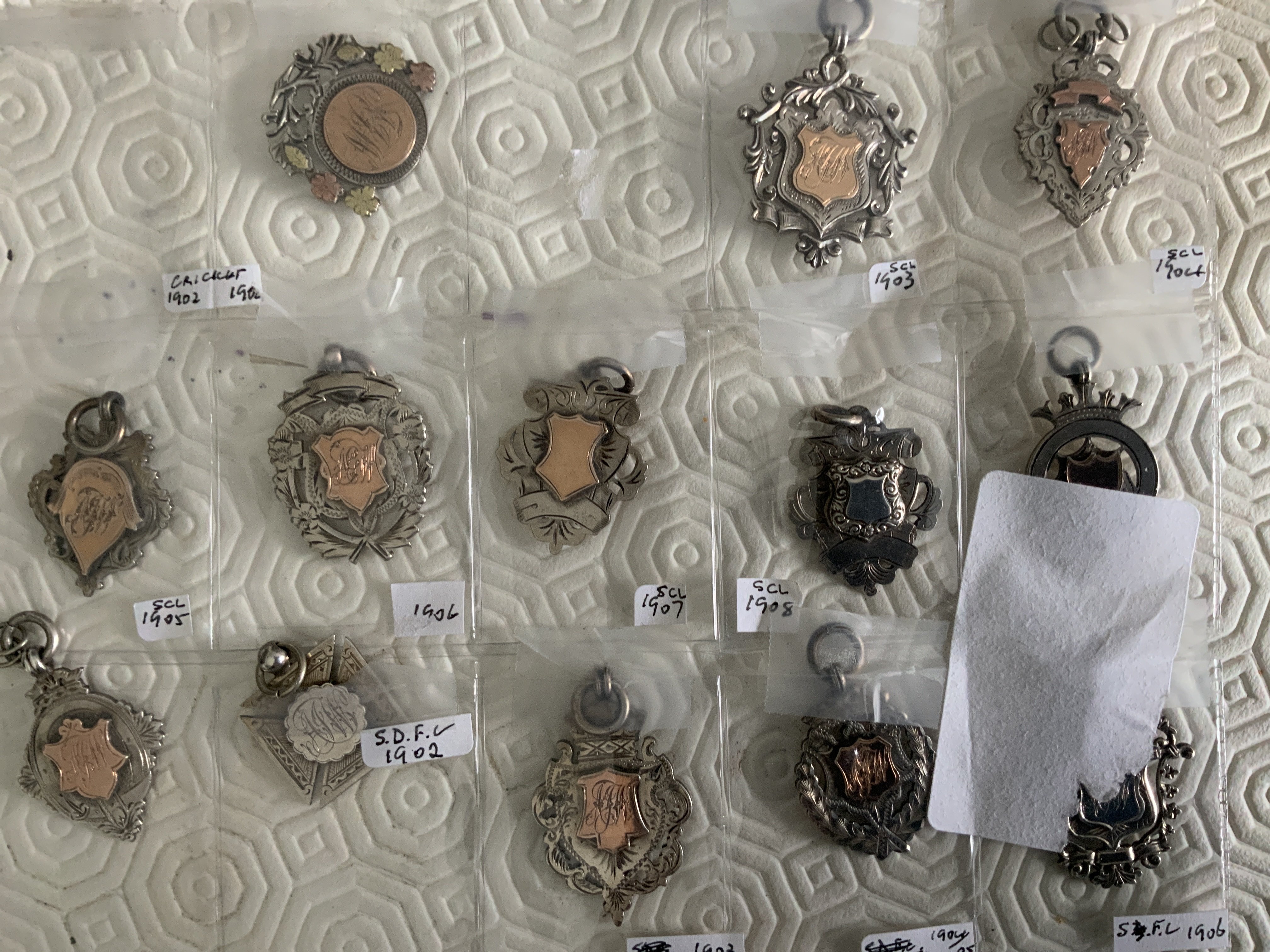 Football Memorabilia Box: Includes complete set of Joe Mercers Cleveland Busts with stand, 1968 club colours poster supplement with Jag, Books, Esso 1970s coin set and badge set plus an Everton rosette.