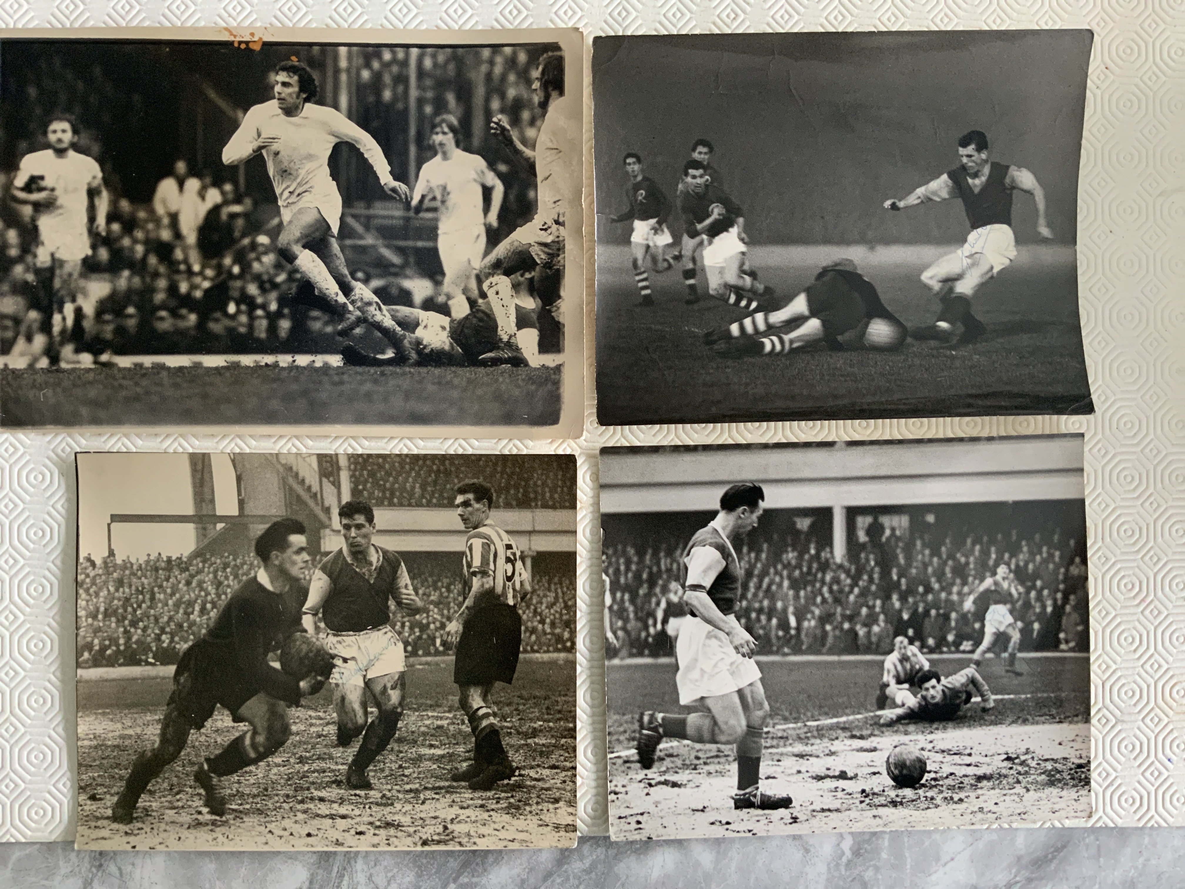 1950s West Ham Signed Football Press Photos: Great match action including John Dick v Rapid Vienna, Musgrove crossing v Lincoln in 1956 and Eddie Lewis v Sheffield United in 1956. Press stamps to all 3 with annotations to 2. C/W action at Arsenal in the FA Cup in 1975. Good large photos with all 3 mentioned payers having signed. (4)