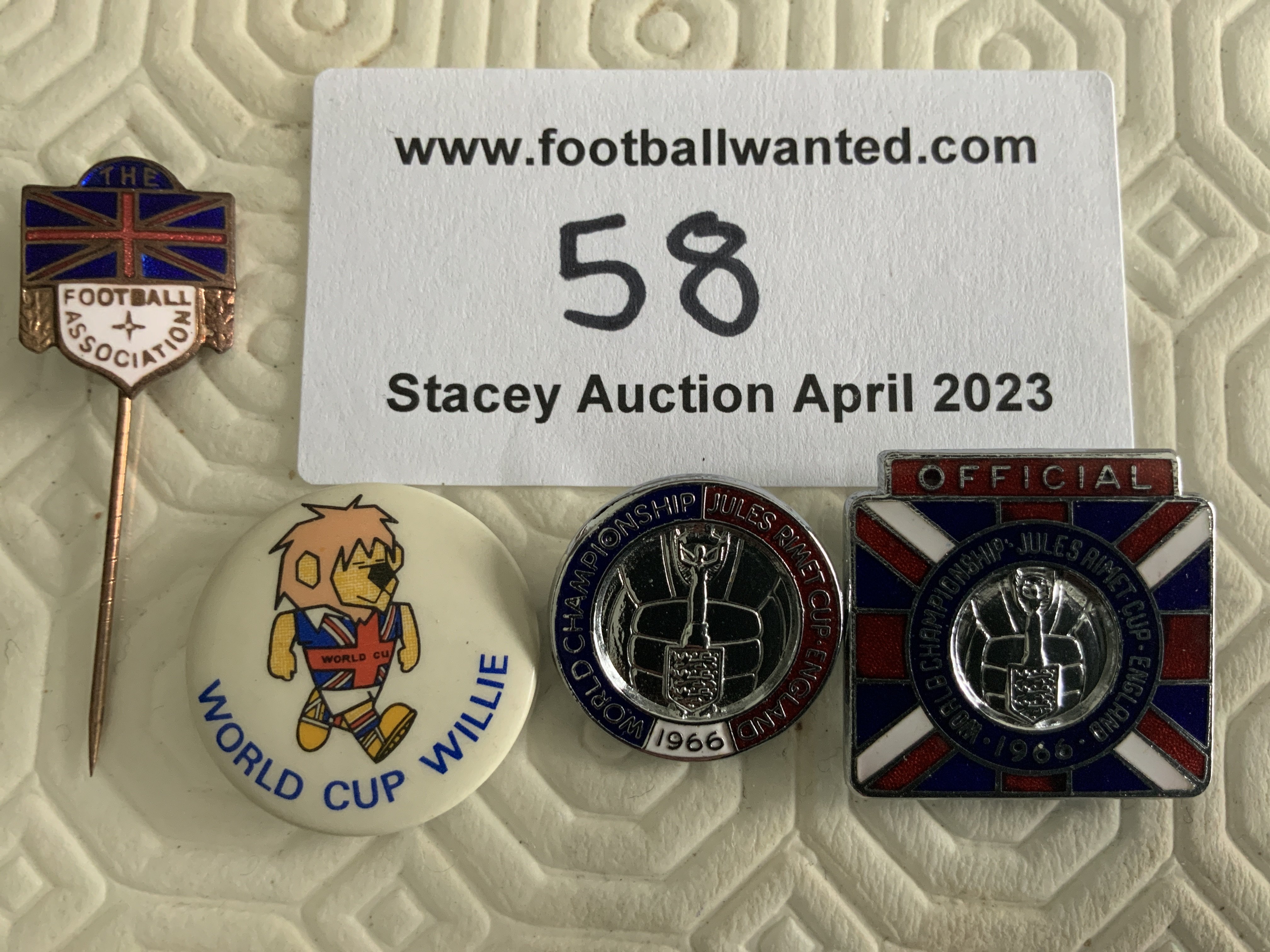 1966 World Cup Football Badges + Patches: World Cup Willie cloth badges in white and black plus a round car sticker. C/W 4 enamel badges of which 3 directly relate to the World Cup. Excellent. (7)