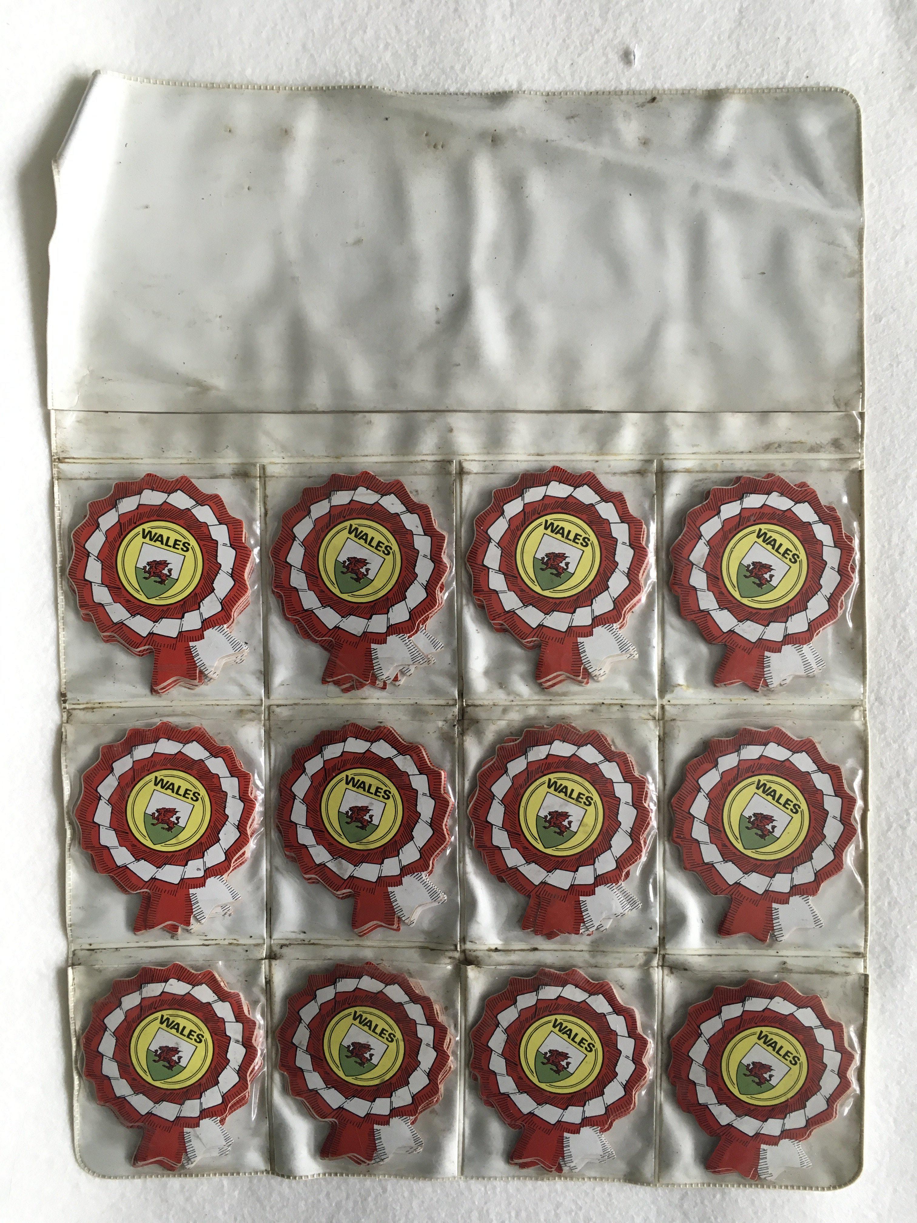 BABS Wales Shop Display Of Rosette Cards: 120 rosette shape Wales Football cards in shop display showing 12 identical cards. Each pouch contains 10 cards. (120)