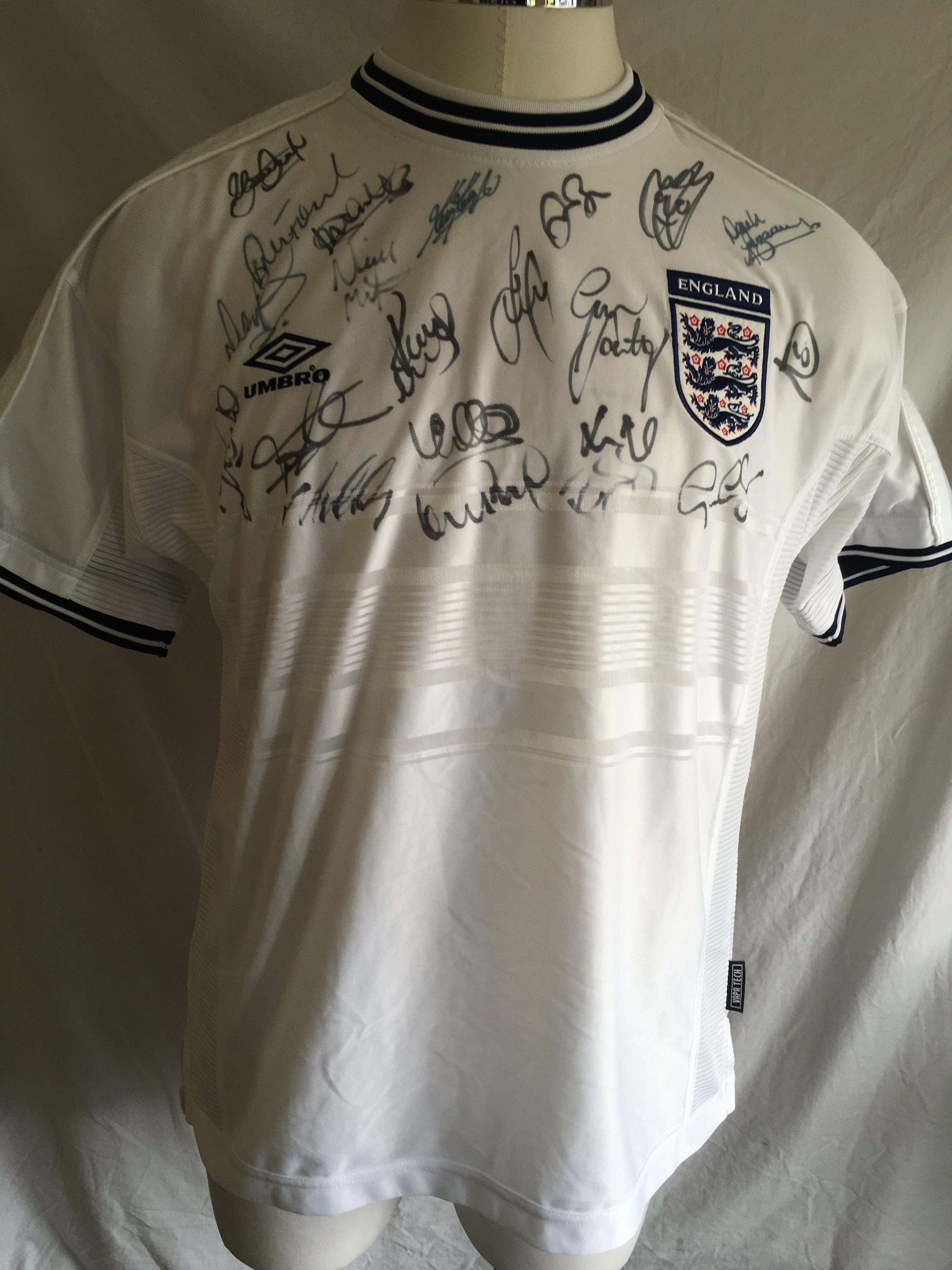 England 2000 Signed Football Shirt: Unused original shirt from 2000 signed by around 20 players including manager for the last ever England match at Wembley Keegan and current manager Southgate. Genuine autographs also from Rio Ferdinand Gary Neville Tony Adams Steve Gerrard and David Beckham.