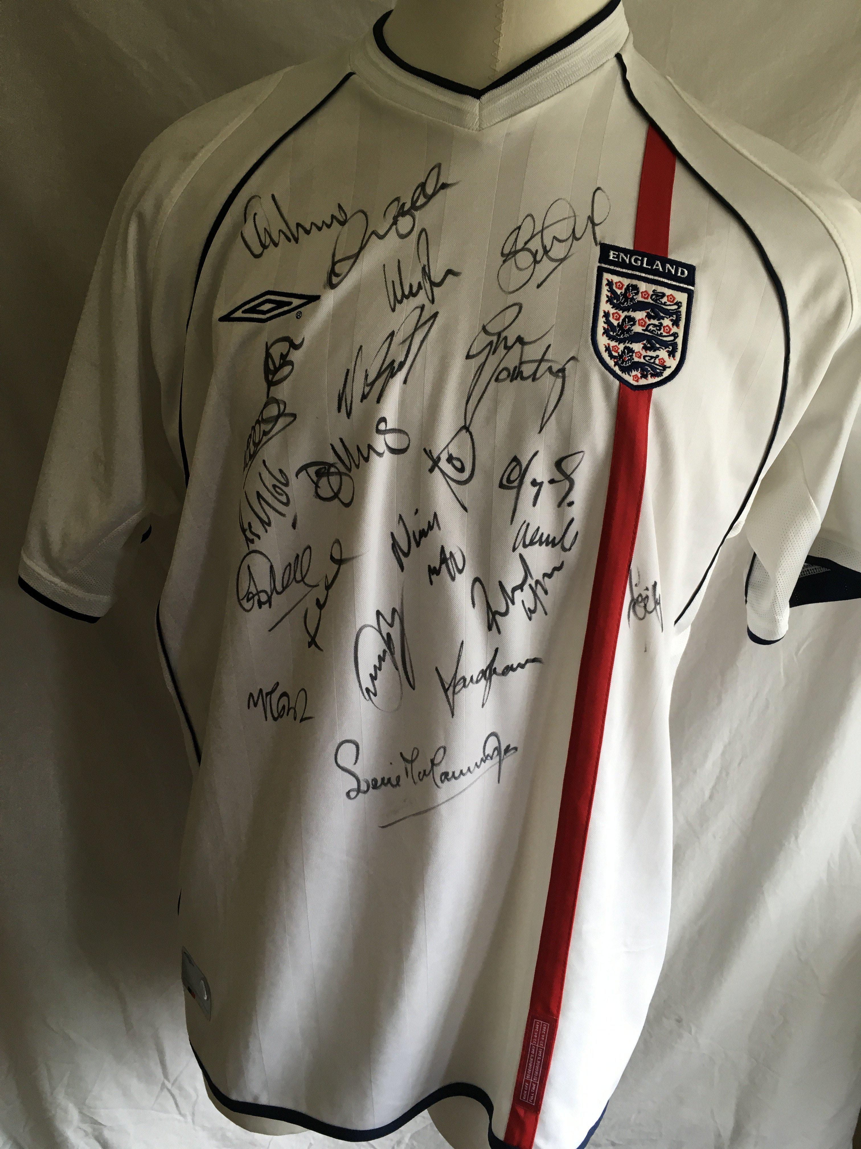 England 2002 Signed Football Shirt: Unused original shirt from 2001 - 2003 signed by 19 players including Gareth Southgate Rio Ferdinand Steve Gerrard Michael Carrick Steve McManaman and David Beckham. Couple of small marks to sleeve.