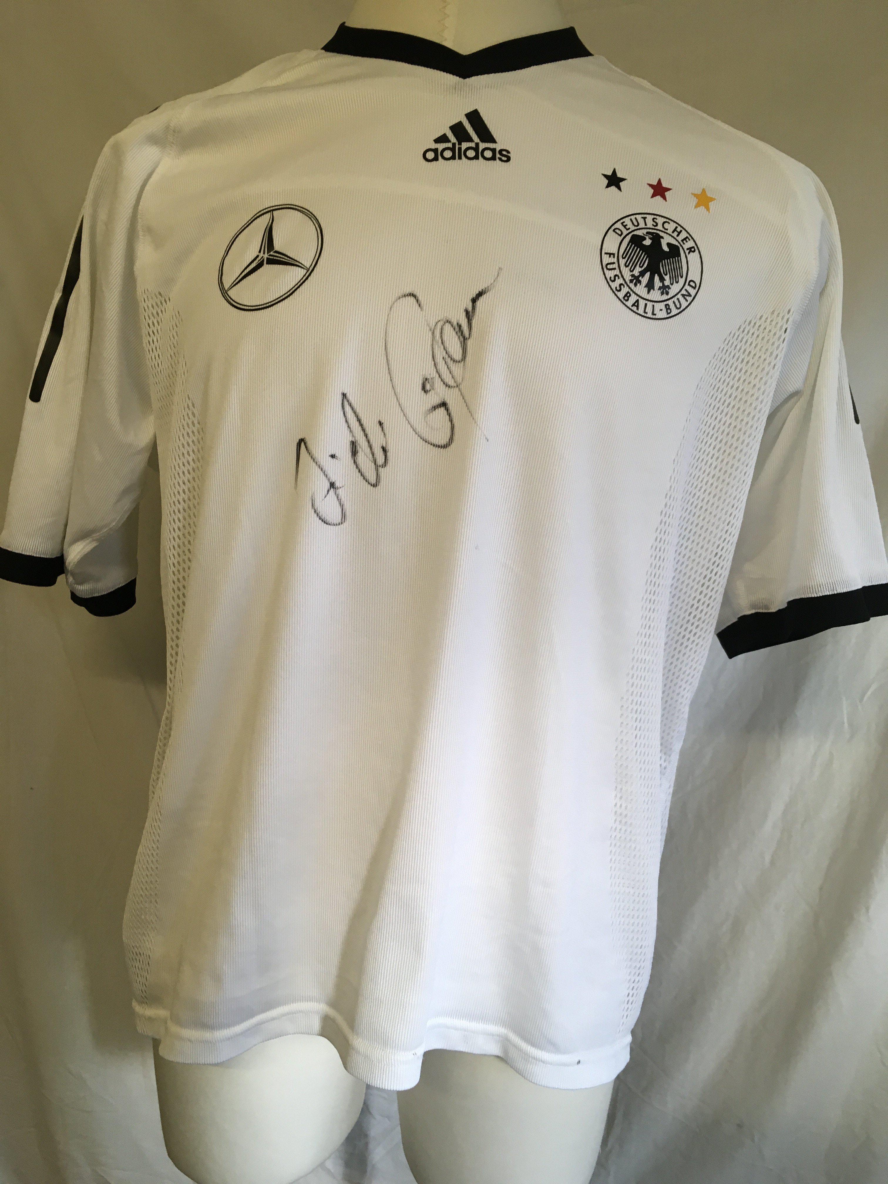 Hamann Germany Signed 2002 Football Shirt: Given to vendor directly by his friend Hamann. Could be a training top as has Mercedes logo to one breast and the usual Adidas logo has moved to the middle with German badge and 3 coloured stars to other breast. Signed clearly without dedication to front by the last goalscorer at Wembley. Inner mesh attached.