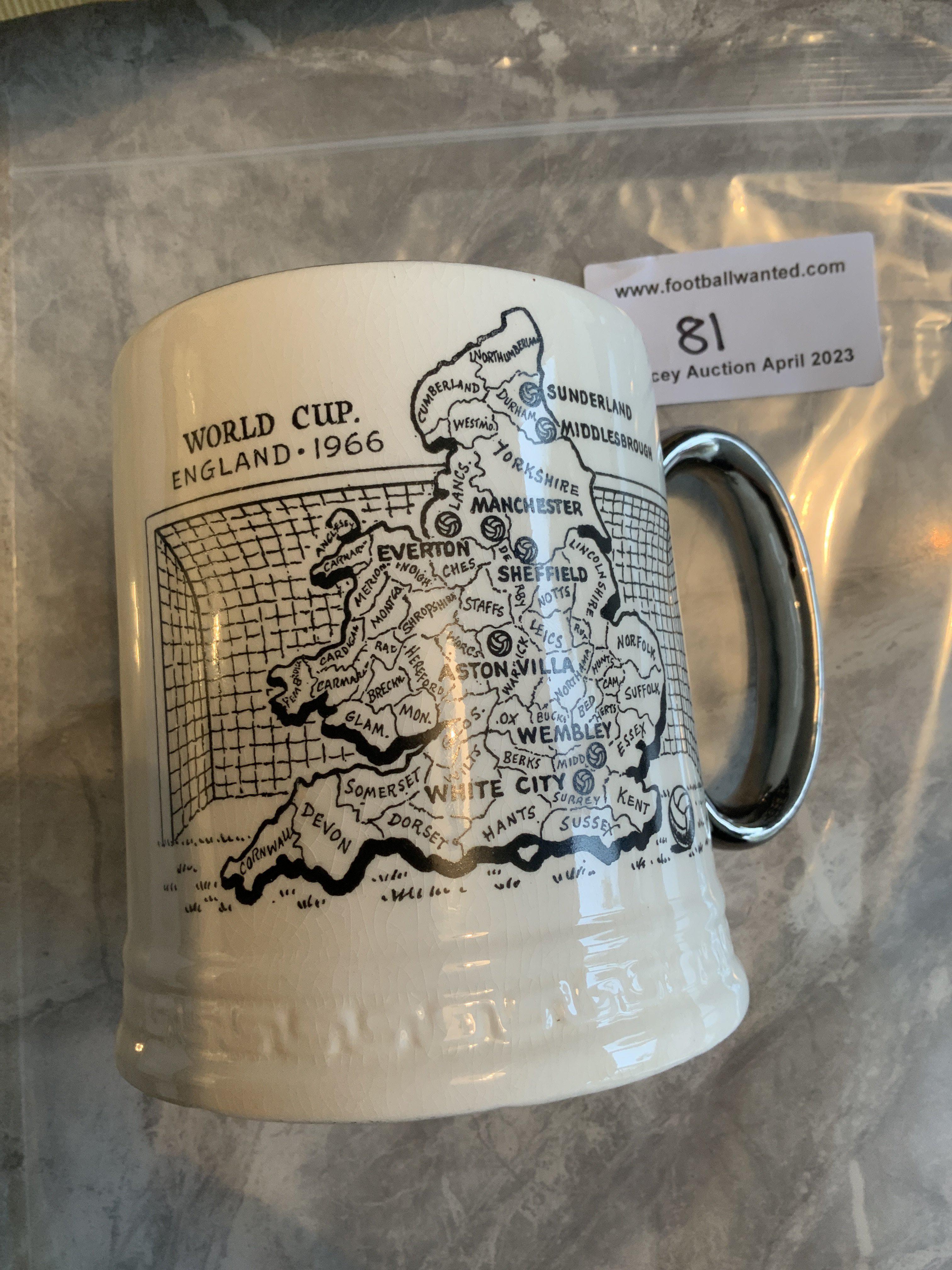 Rare 1966 World Cup Ceramic Tankard: The rare one made by Moslem of Stevenage, although this is not stated. Beautifully made with silver coloured handle and trim. One side depicts the 8 venues to be used and the other the 16 participating nations. 100% original in stunning condition. Base reads Britannia Designs.