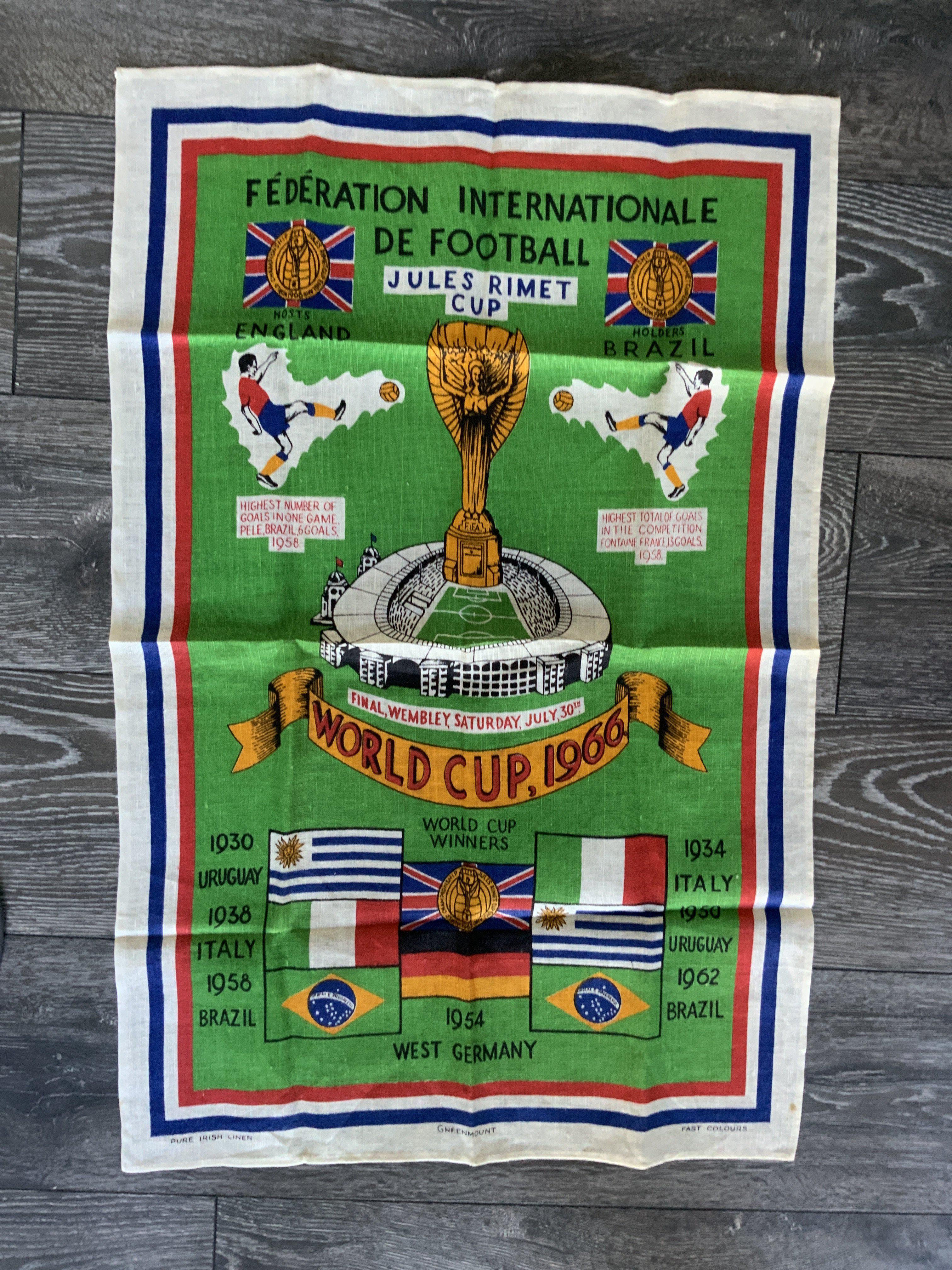 1966 Football World Cup Linen Tea Towel: Stunning unused large colourful tea towel with the World Cup logo plus names and flags of previous winners. Jules Rimet pictured above Wembley with date of the final below. Measures 31 x 20 inches.