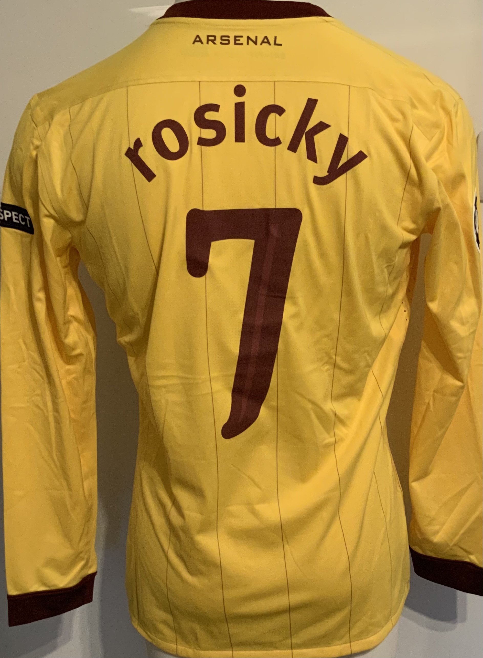 Arsenal 2010 - 2011 Match Worn Football Shirt: Yellow long sleeve with Champions League badging to arms. Number 7 Rosicky to rear.