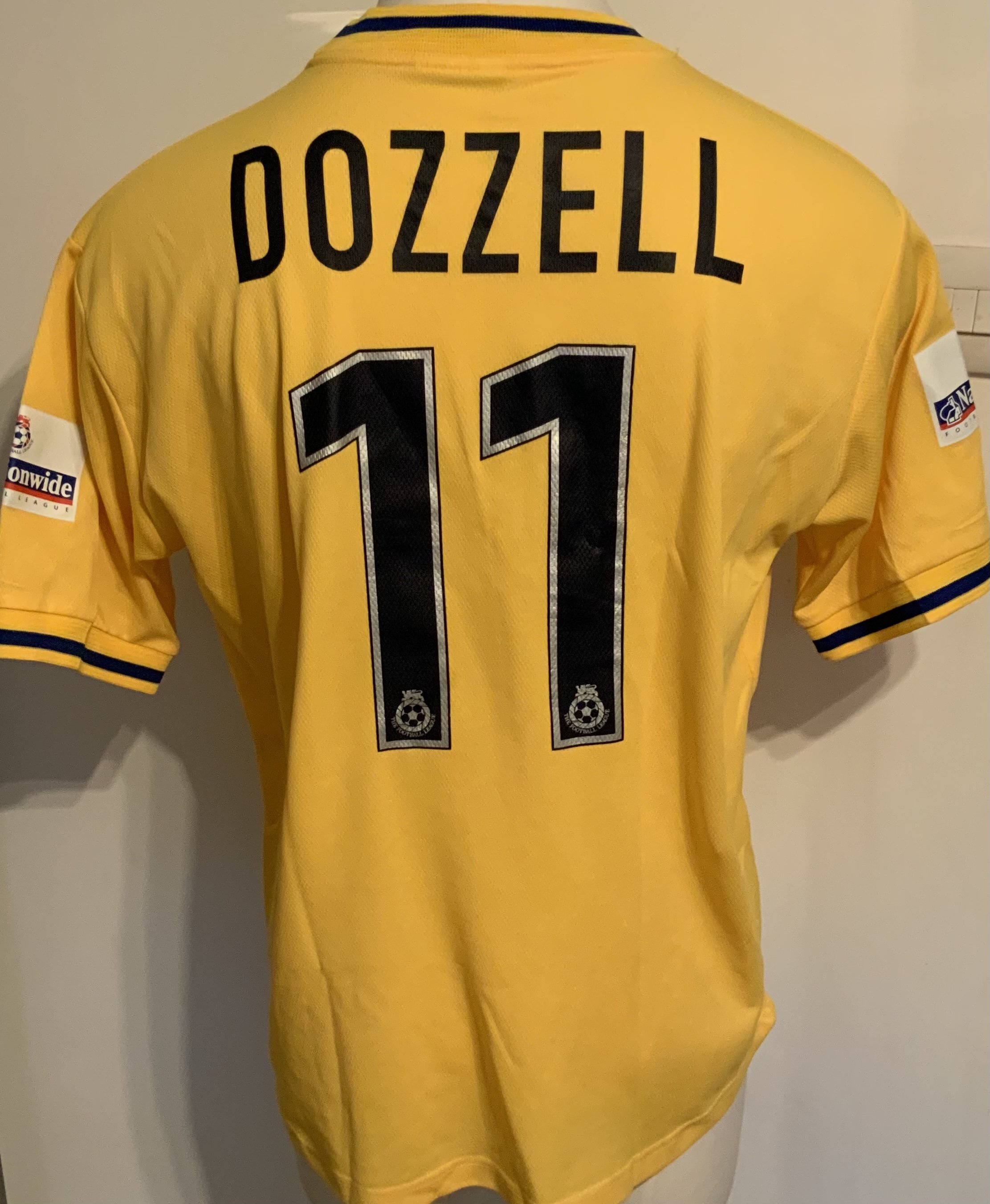 Colchester United 2001 - 2002 Match Worn Football Shirt: Yellow short sleeve with Nationwide badging to arms. Tear on front of collar. Number 11 Dozzell to rear.