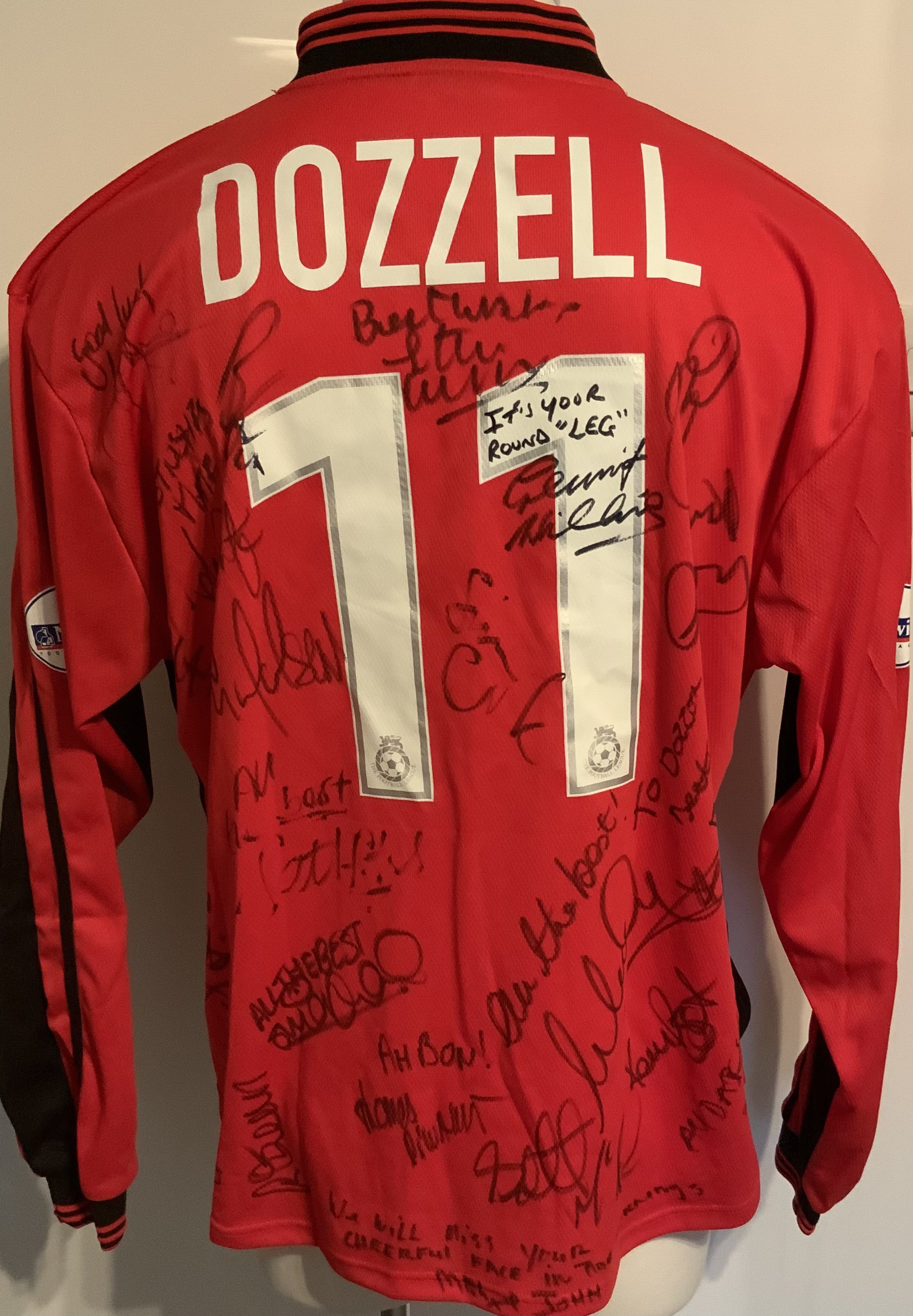 Colchester United 2001 - 2002 Match Worn Football Shirt: Red long sleeve with Nationwide badging to arms. Number 11 Dozzell to rear. This shirt was presented to him by the team when he left and is signed by the squad with messages.