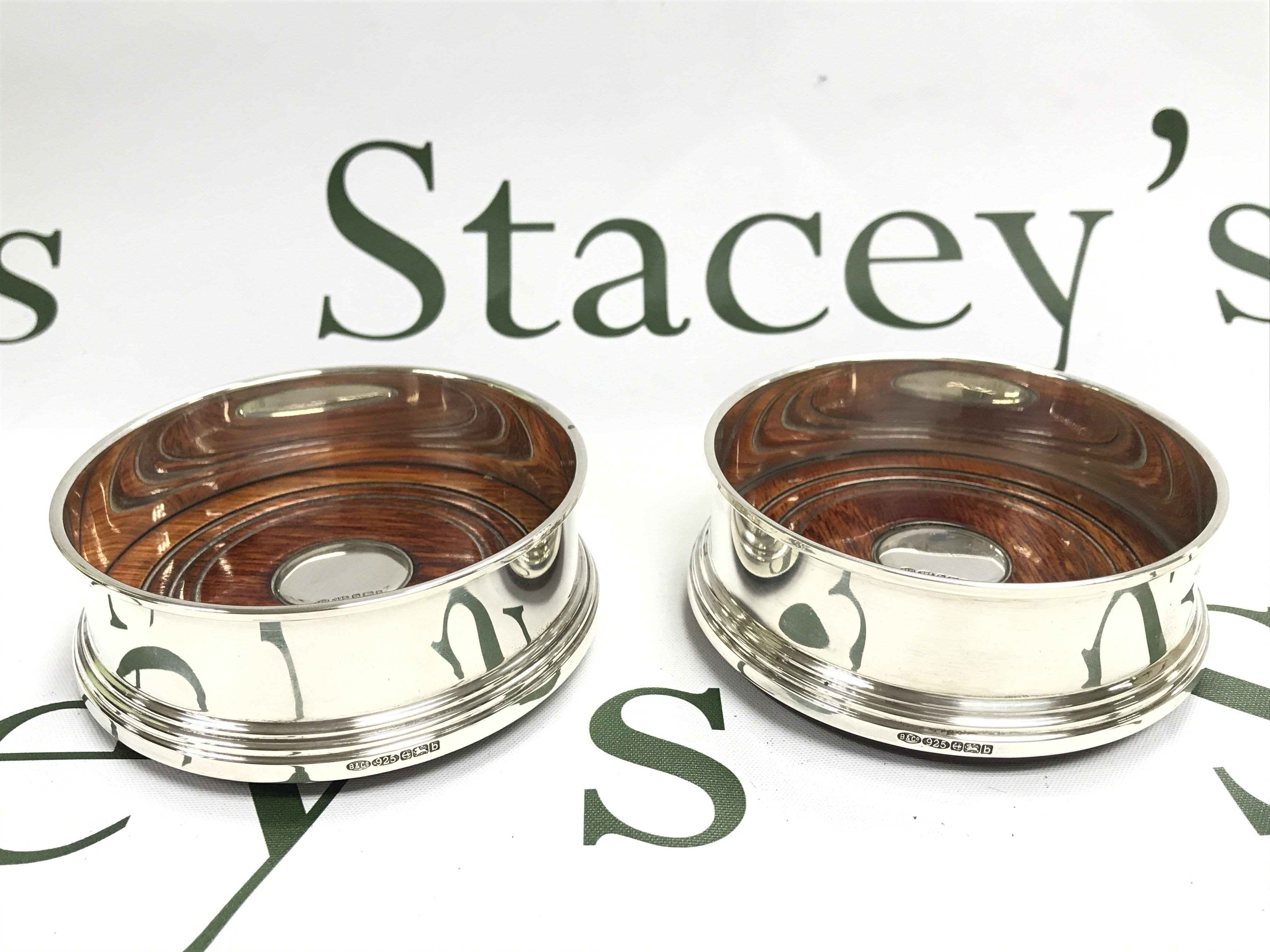 A pair of silver Hallmarked coasters, postage category B