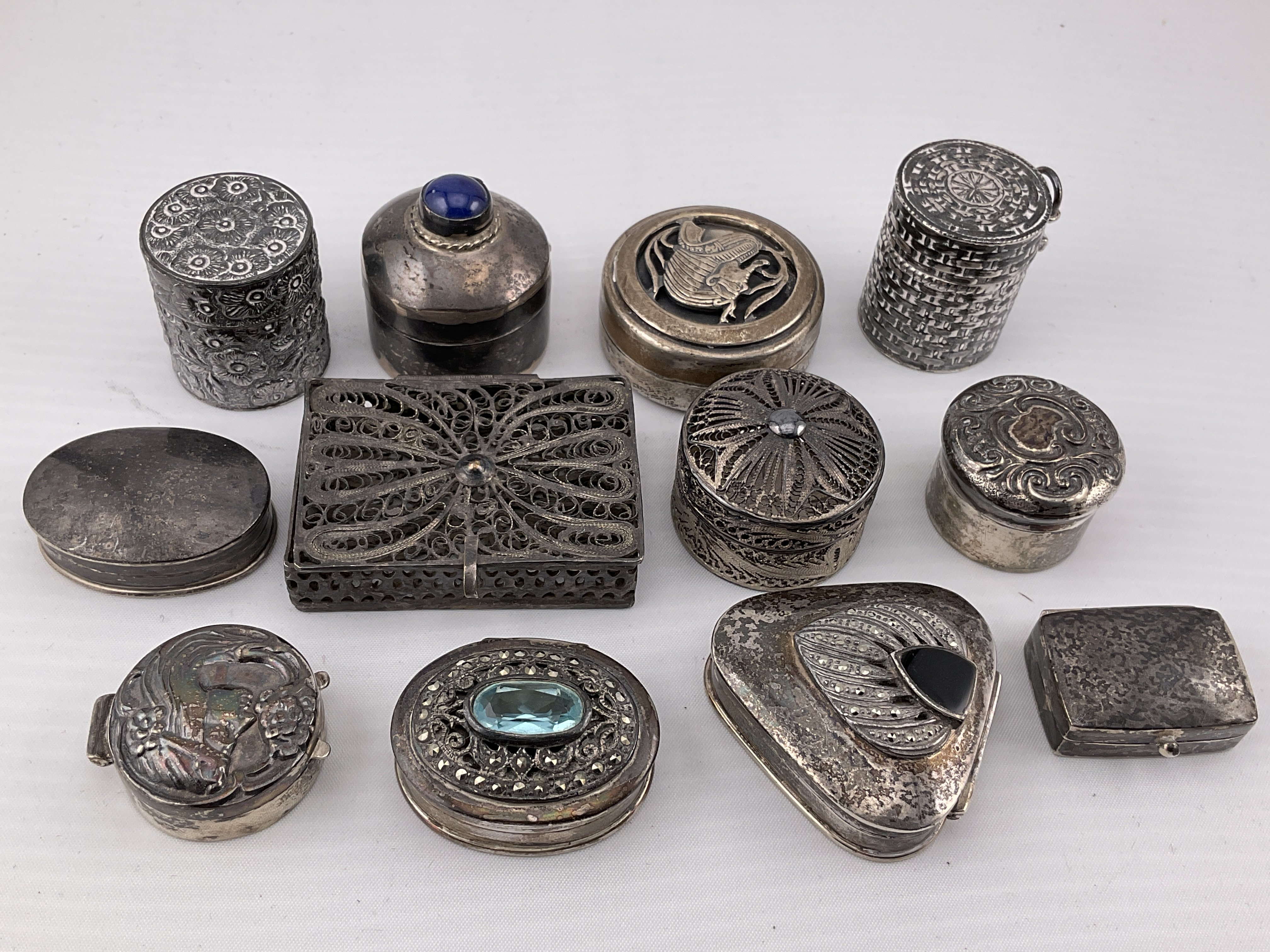 A collection of silver and white metal pill boxes. Postage category A.