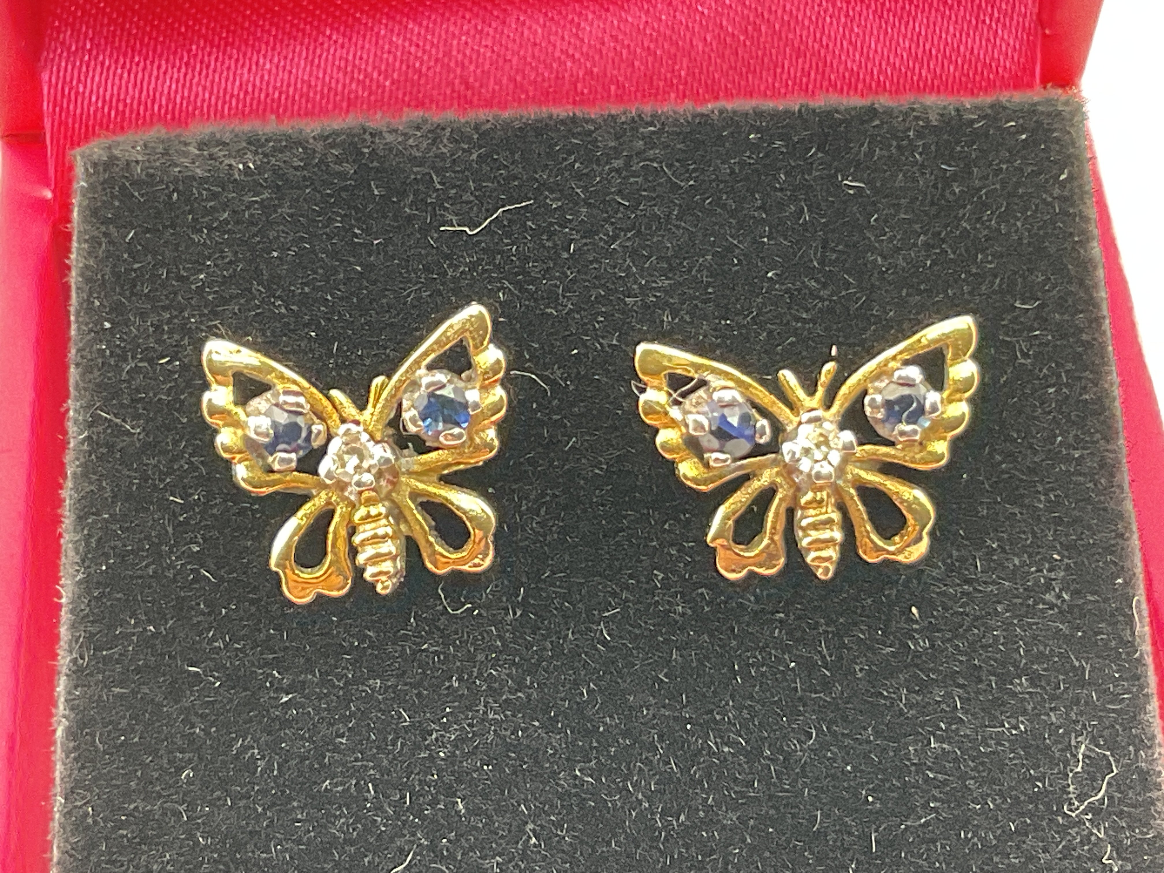 A pair of 9ct yellow gold butterfly earrings set with sapphires and diamond. Postage category A.