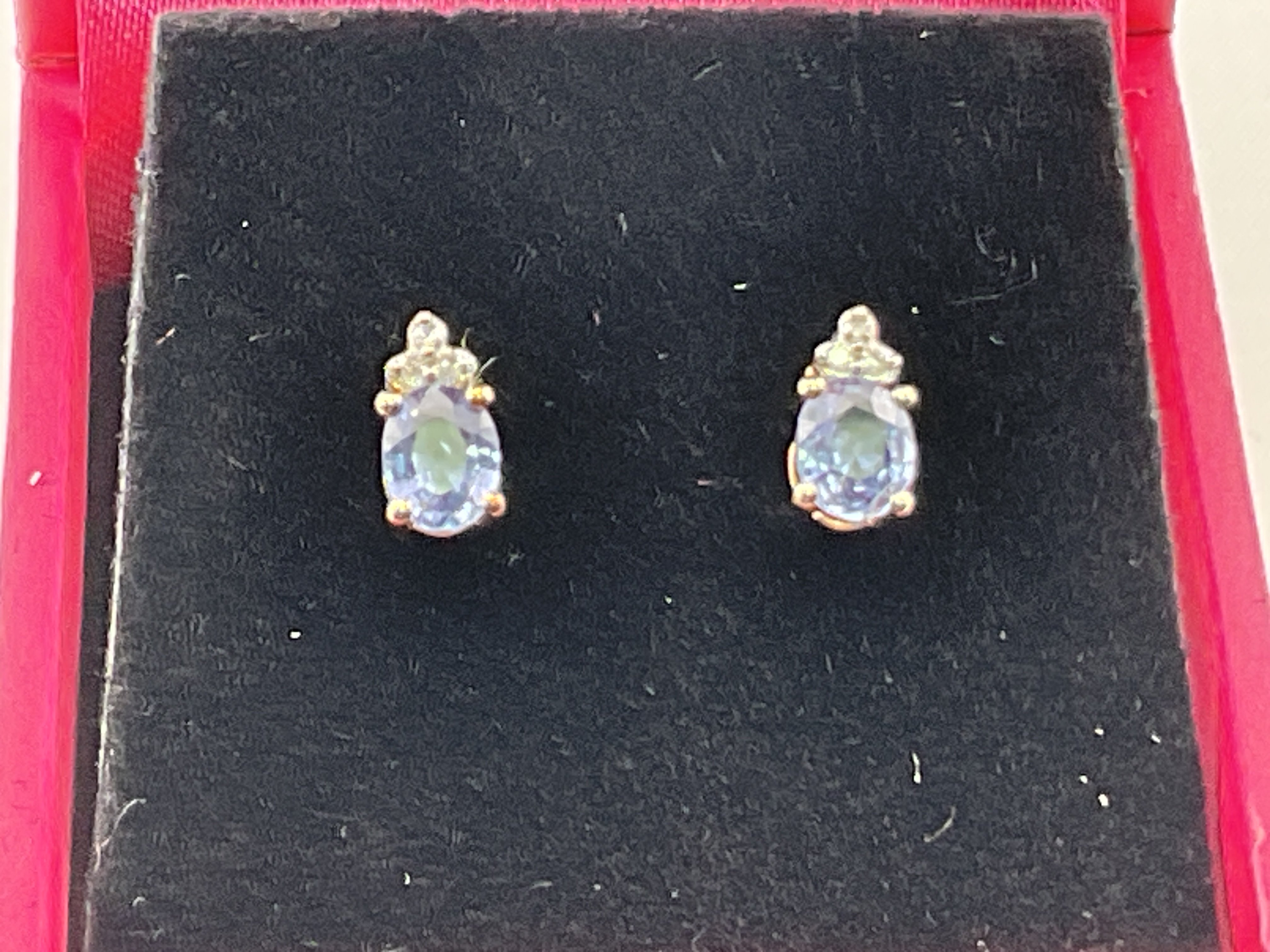 A pair of 9ct gold diamond and tanzanite earrings. Postage category A.