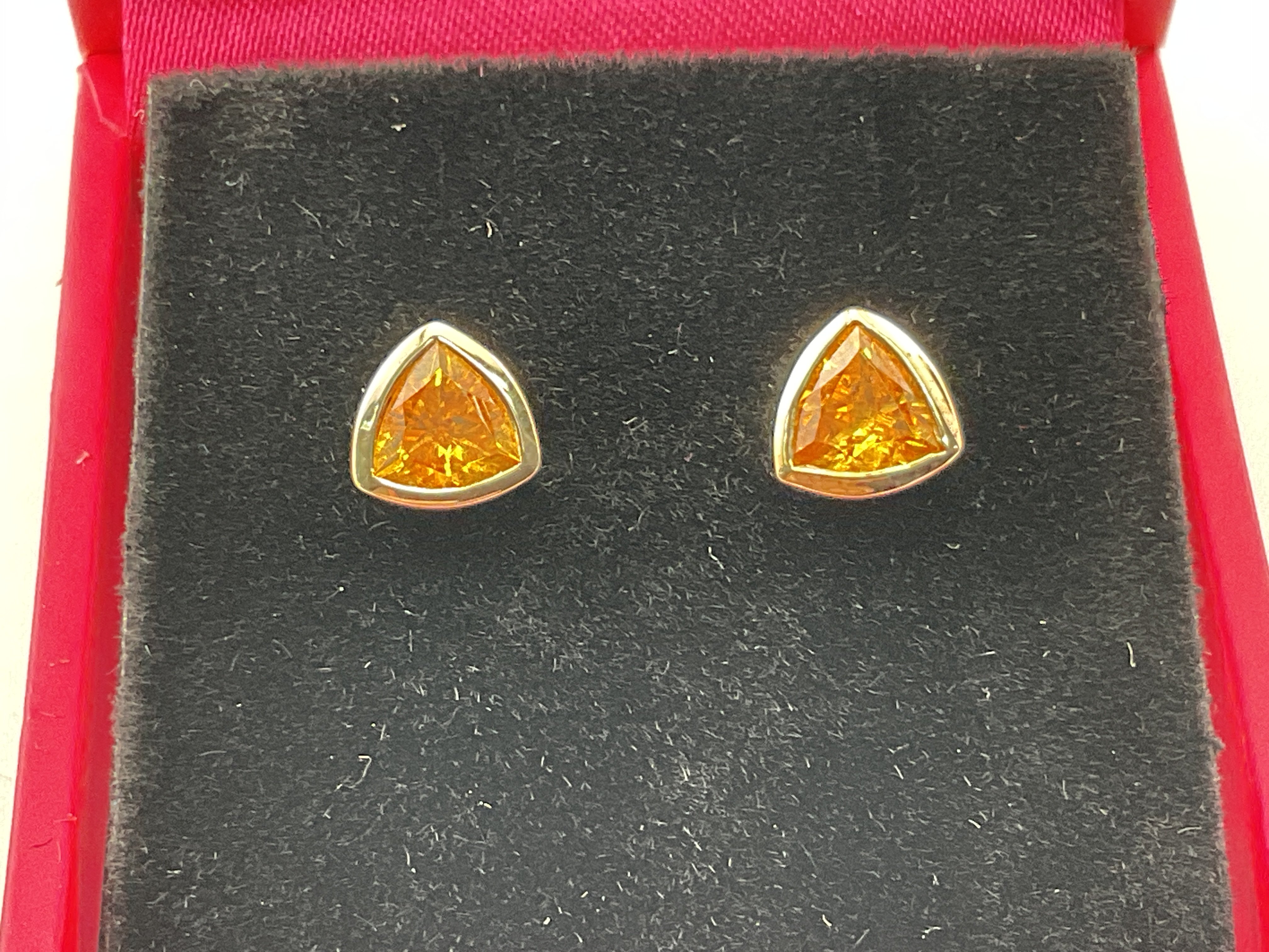 A pair of 9ct gold earrings set with citrine. Postage category A.