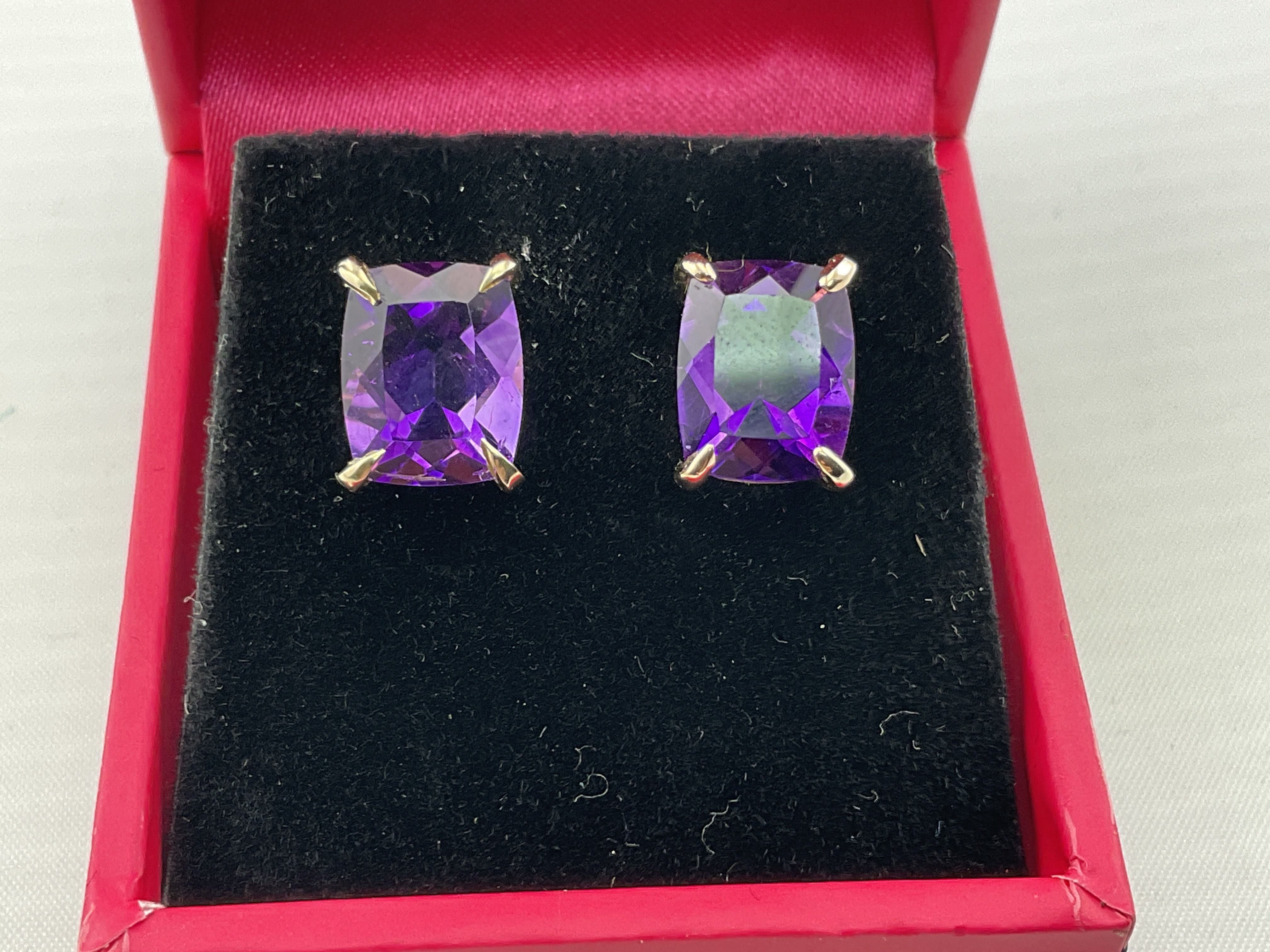 A pair of 9ct yellow gold earrings set with amethyst. Postage category A.