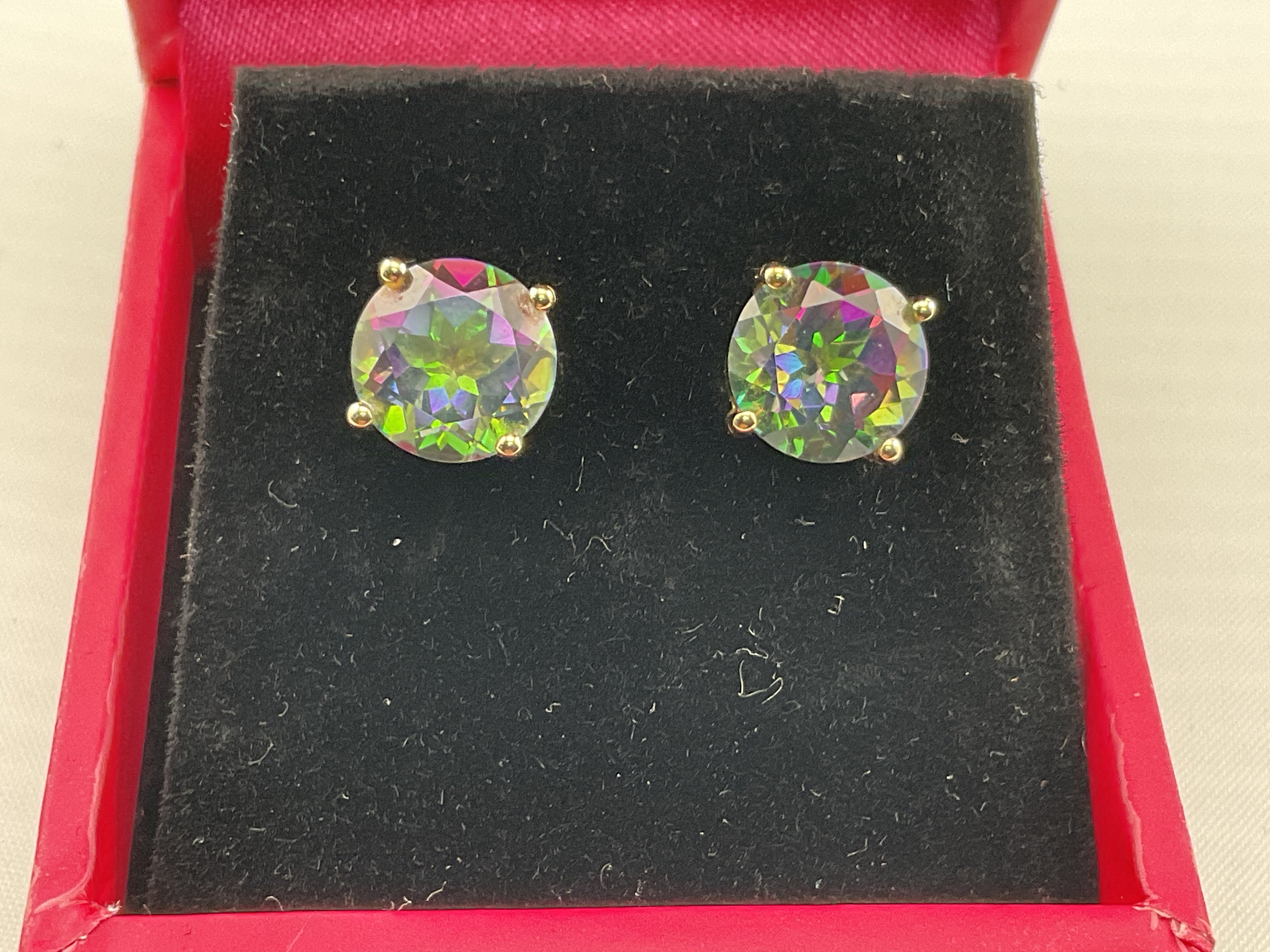 A pair of 9ct gold earrings set with mystic topaz. Postage category A.