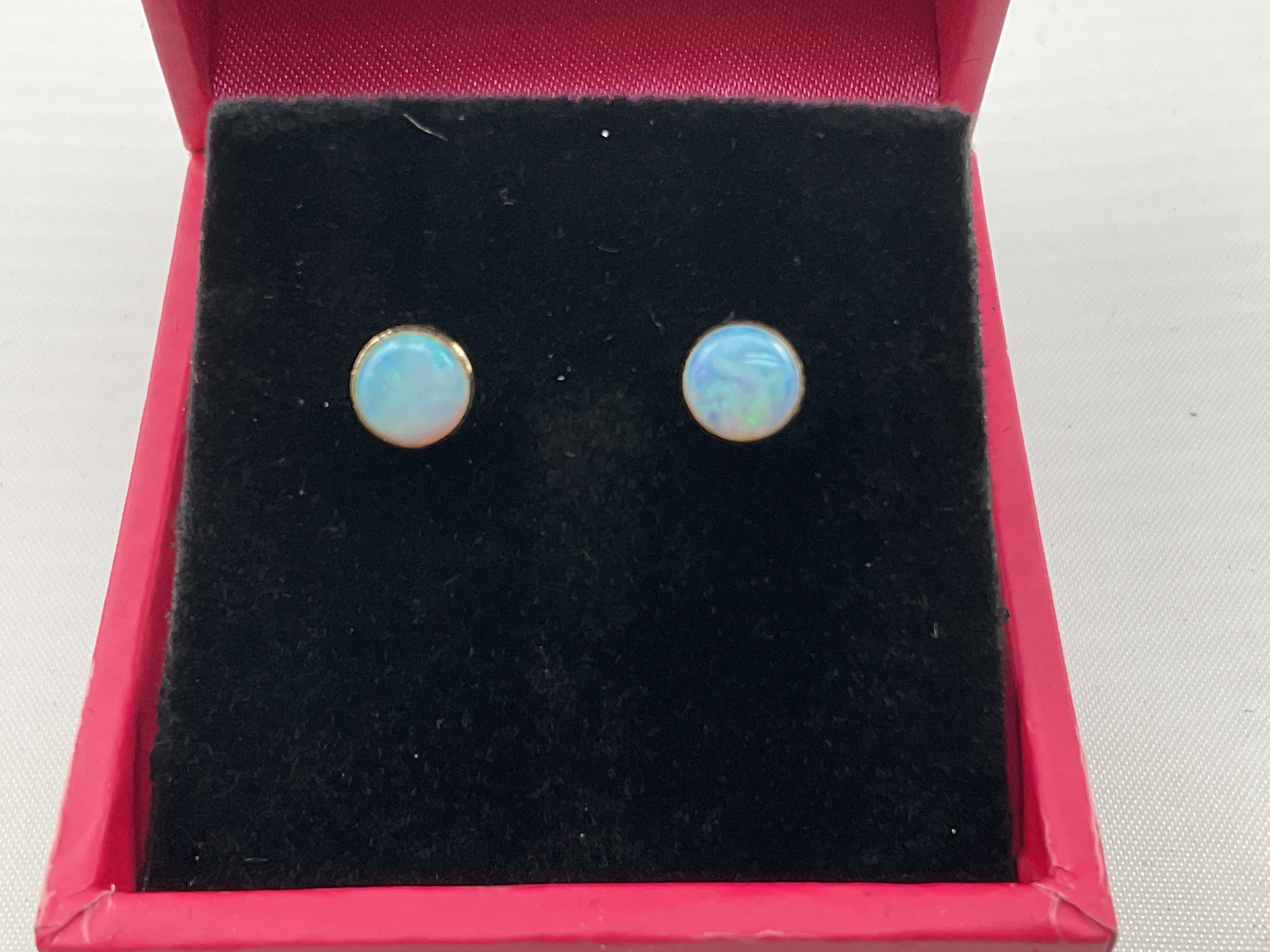 A pair of 9ct gold studs set Opal. Postage category A.