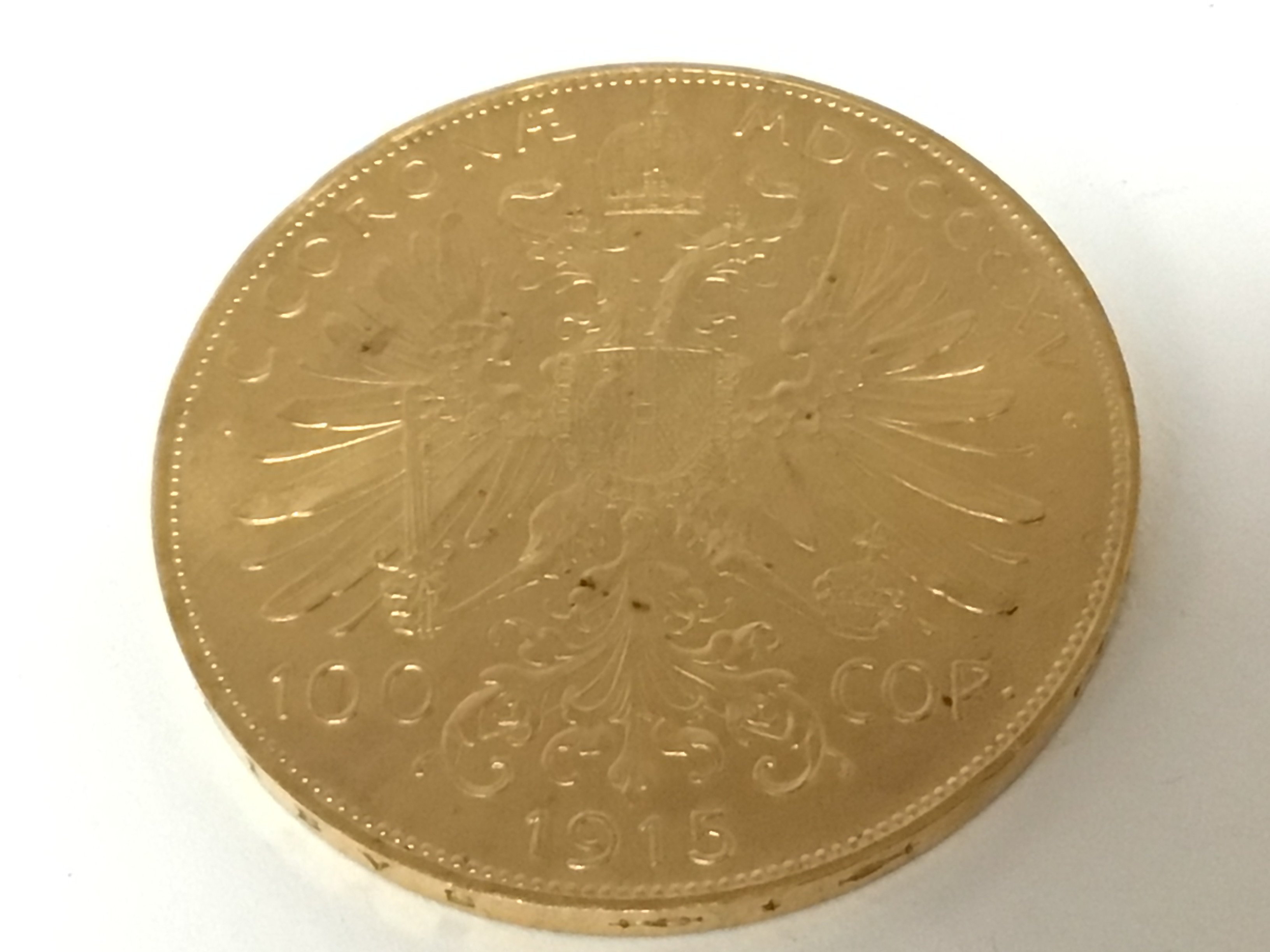 A 1915 gold Austrian 100 Corona coin with the side profile of Francis Joseph I.weight 33.9g