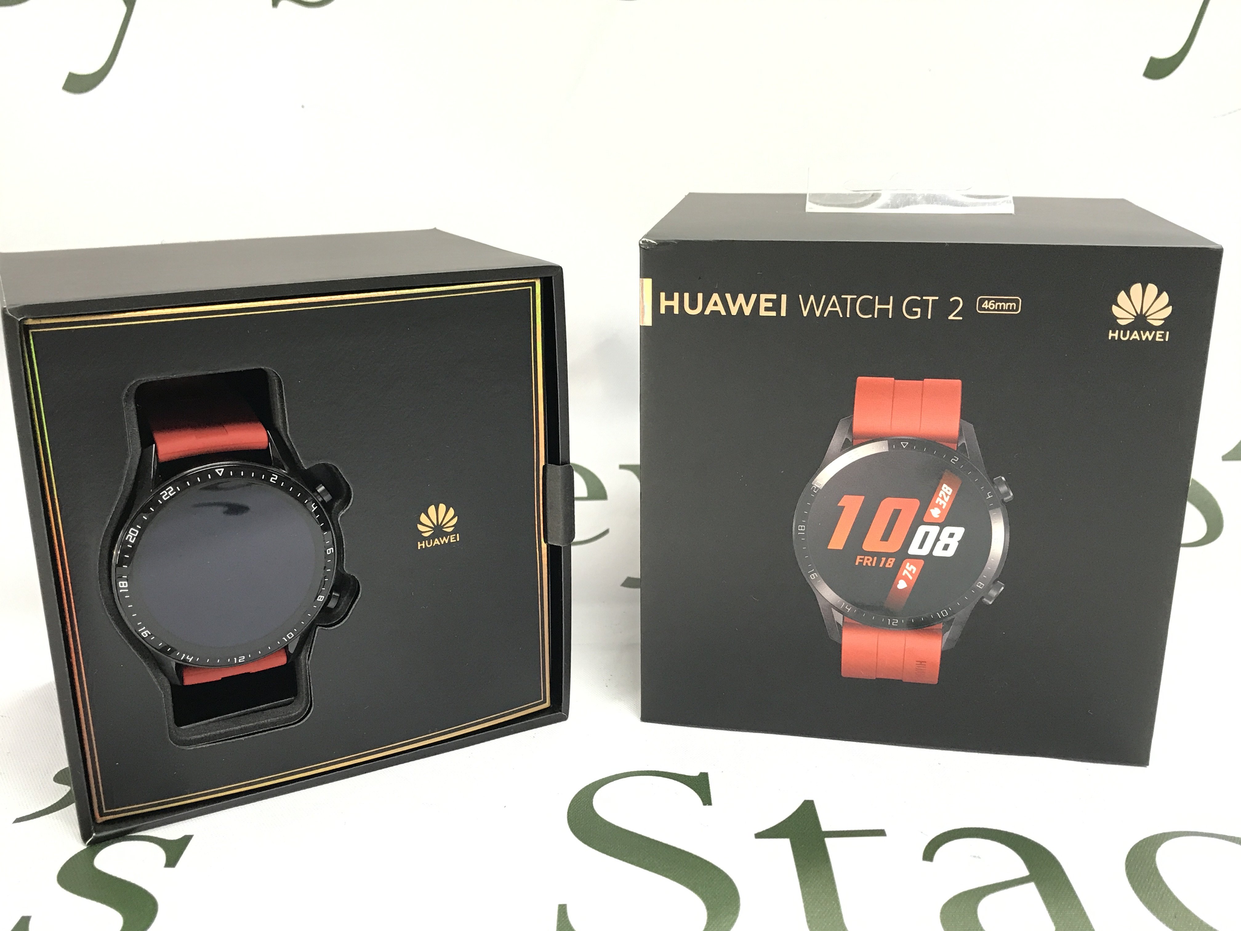 Boxed smart watches including a Huawei GT2 (seen working) and a Sunto core watch. Postage category B