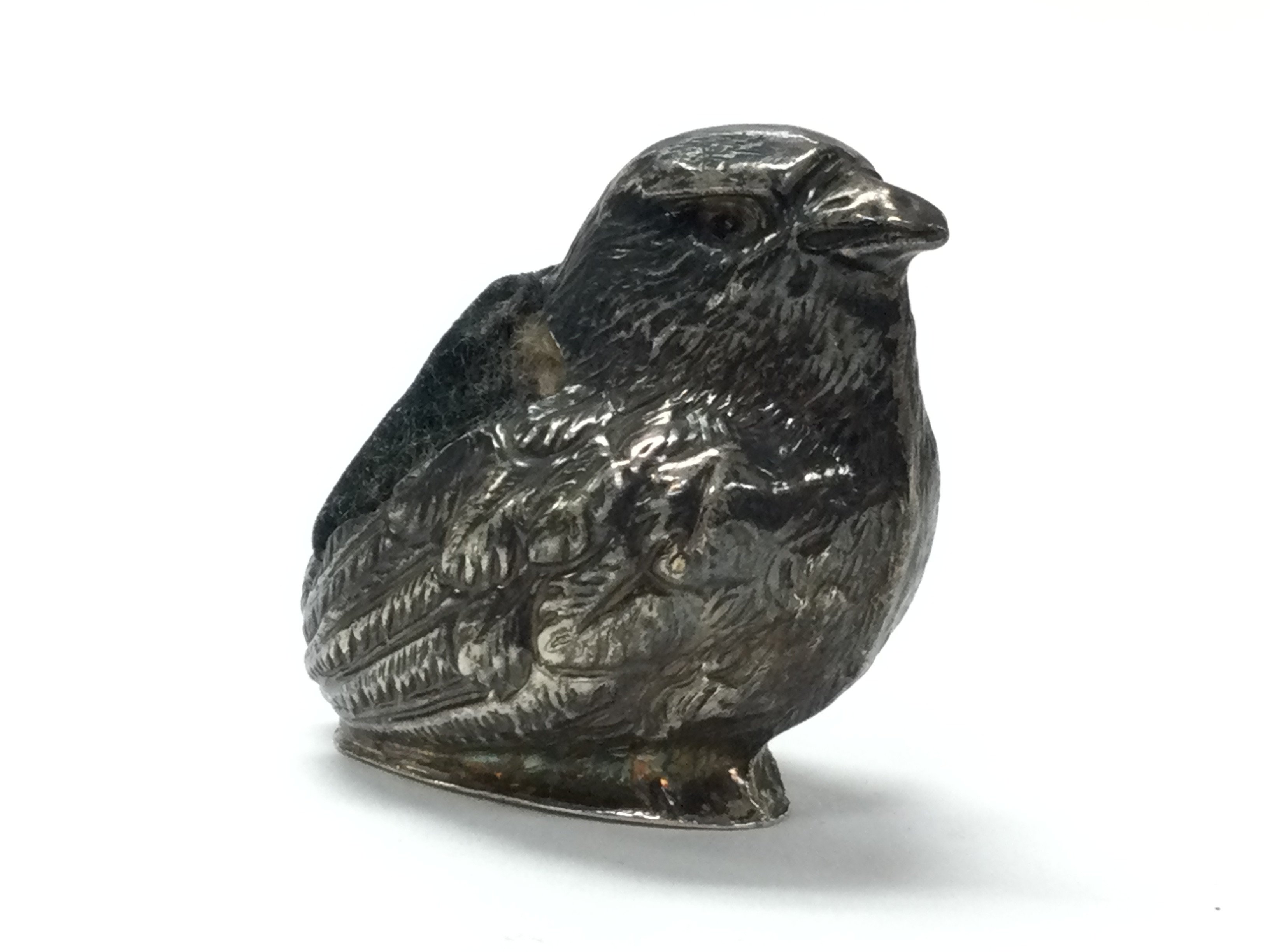 A 1906 silver Chester hallmarked bird pin cushion by Sampson and Mordan. 3.5cm tall. Postage category A