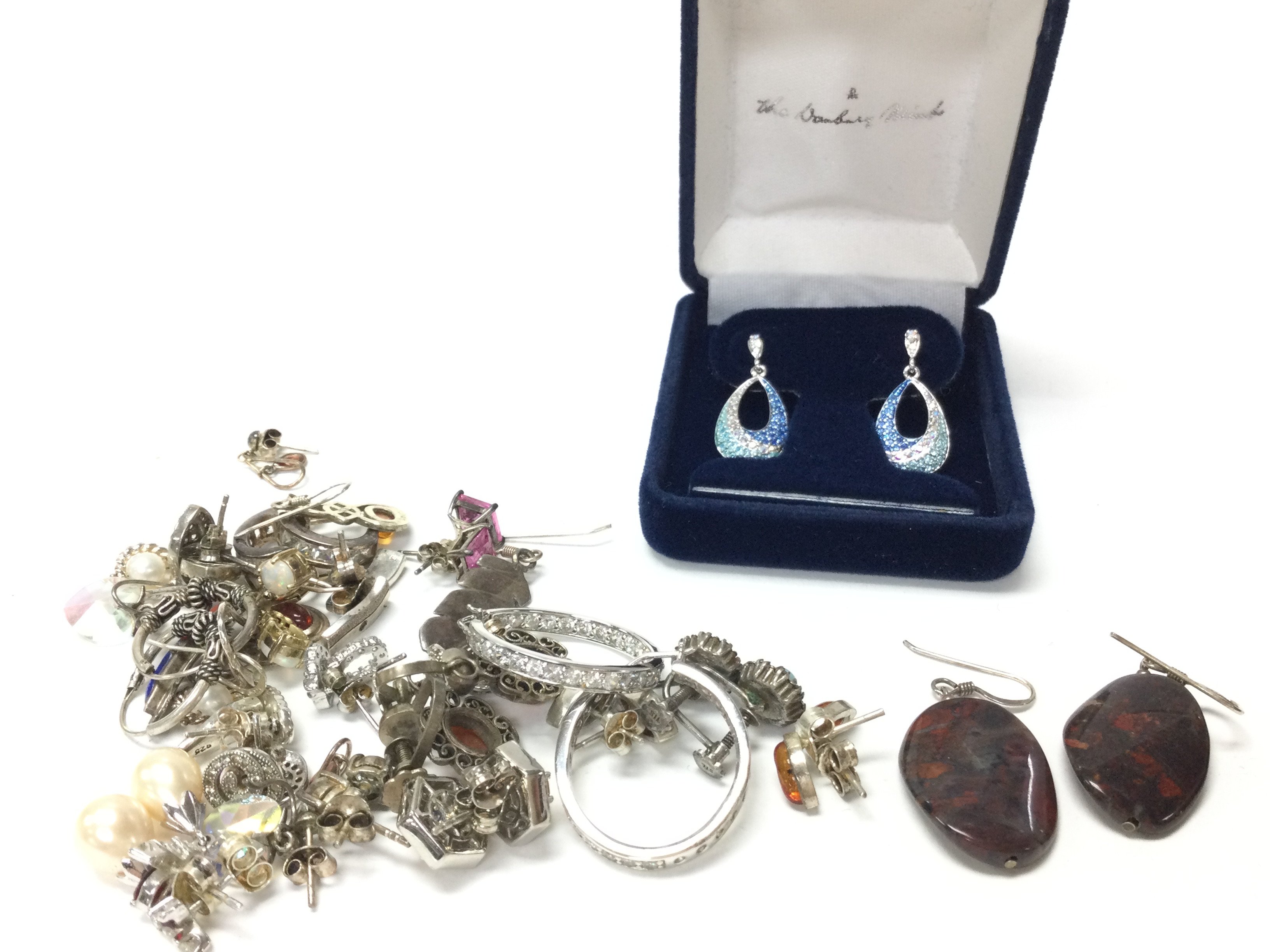 A collection of silver earrings. Postage category A