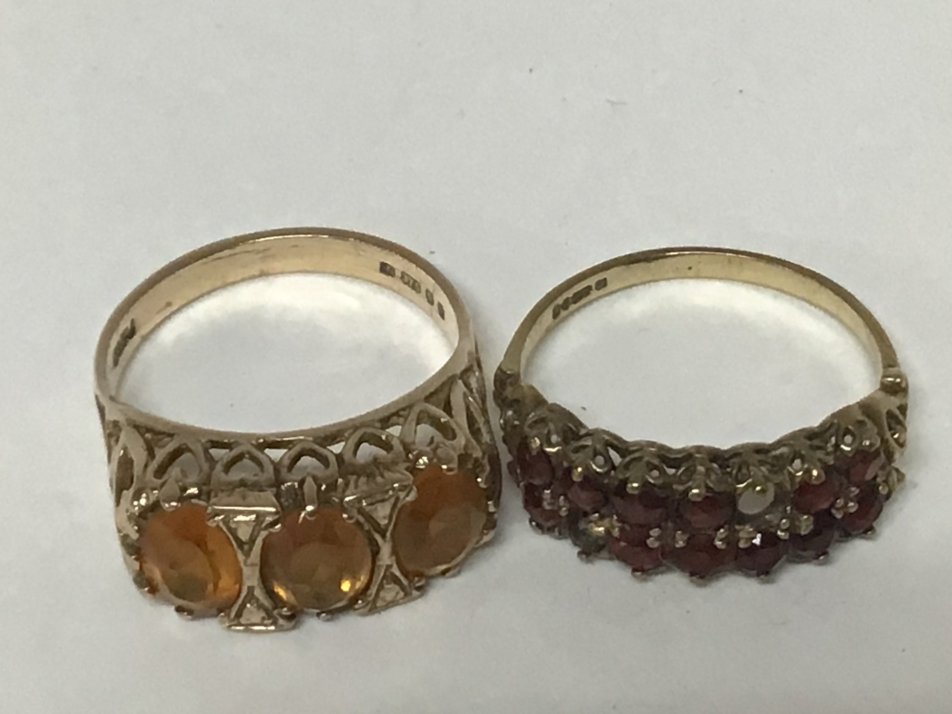 Two 9carat gold rings set with garnets and one other ring set with yellow citrine weight 5.8g
