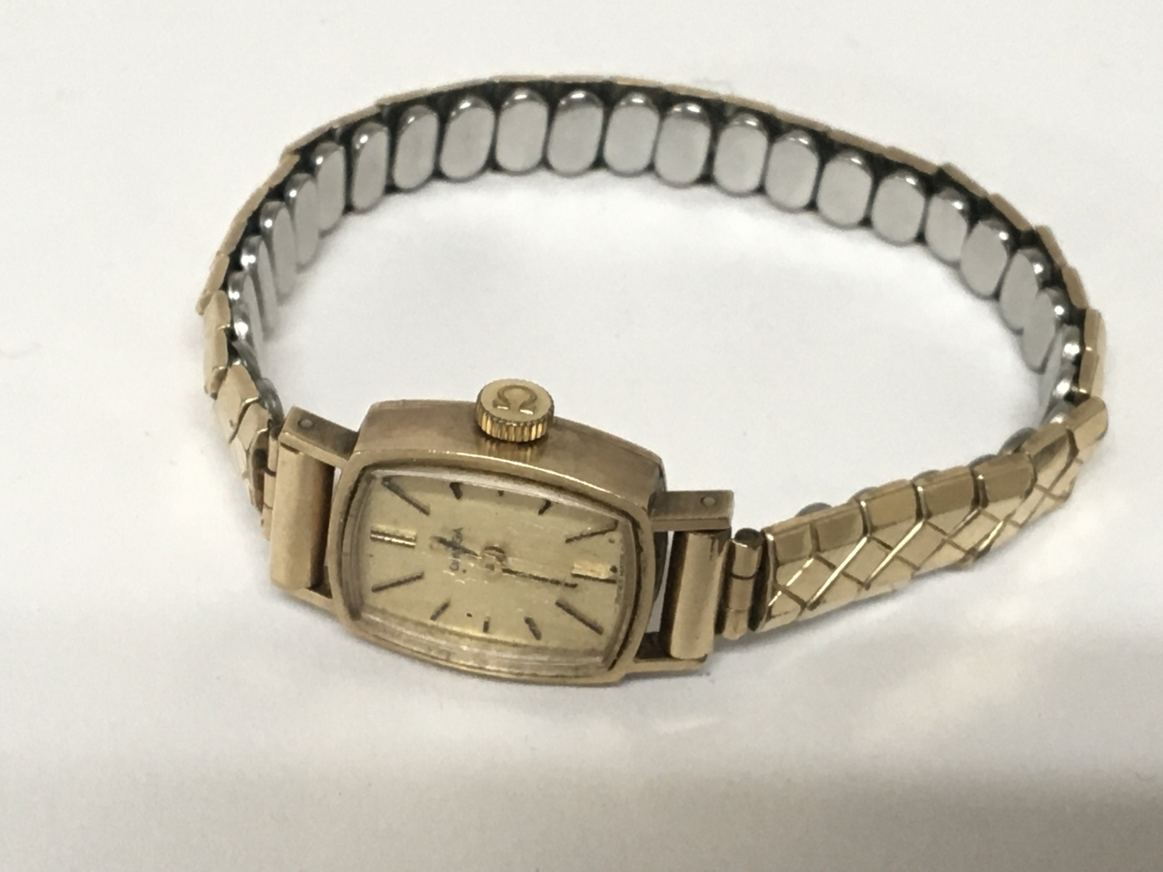 A ladies 9carat gold cased Omega wrist watch with a replacement metal strap.