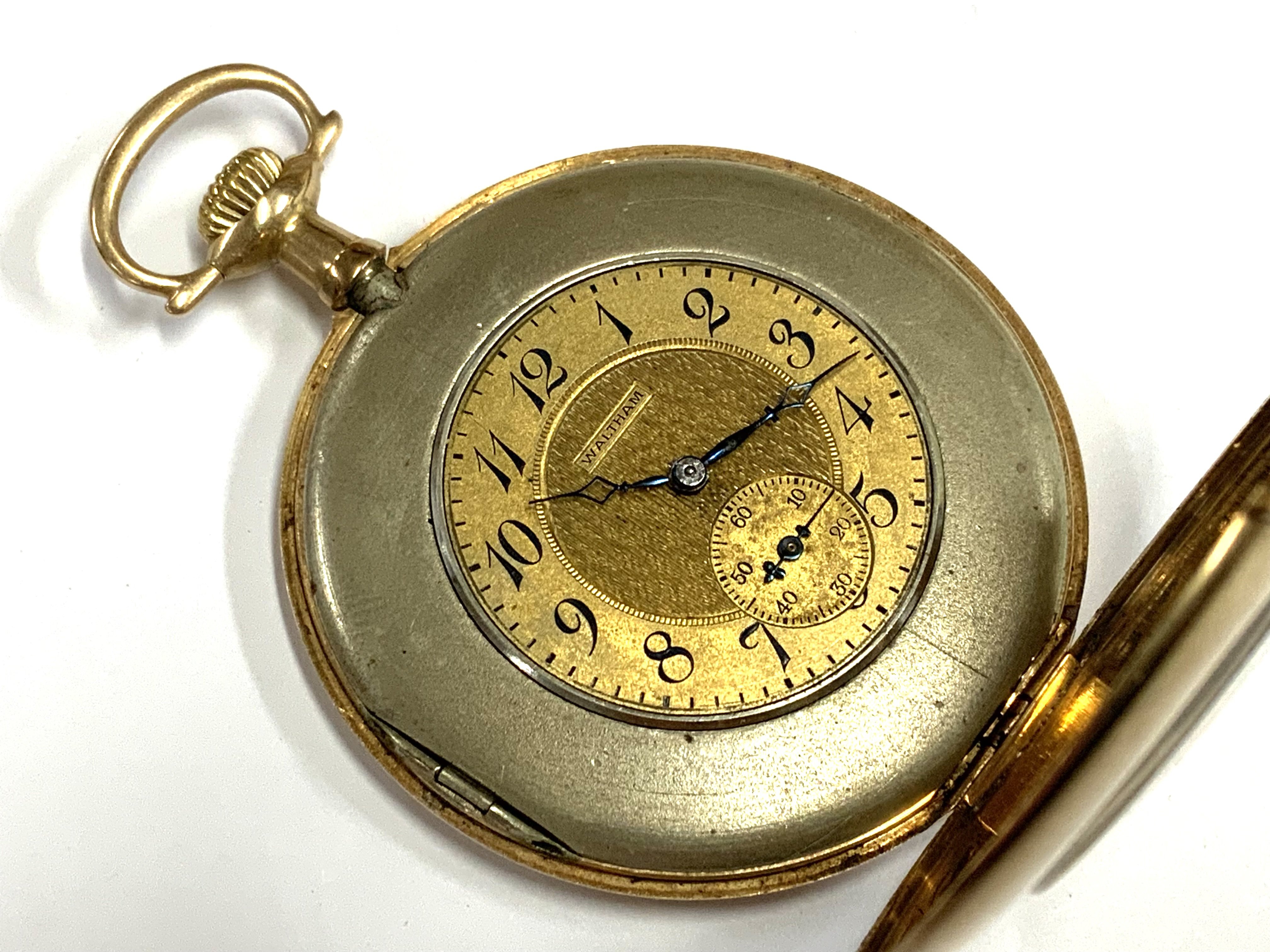 An unusual 14ct gold wide rimmed Waltham pocket watch together with a 14ct gold albertine. 61.06 total weight (A)