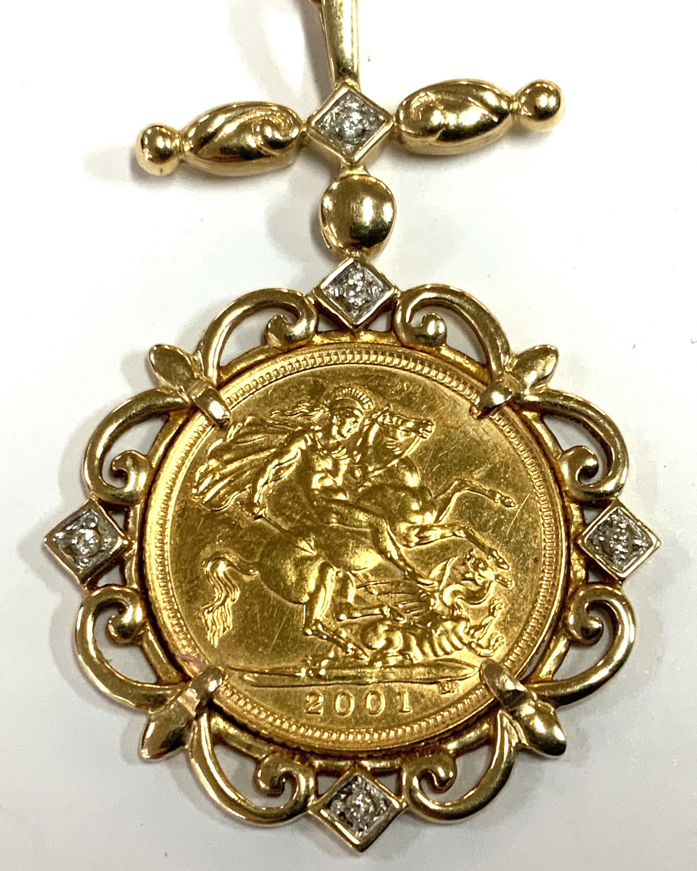 Elizabeth II 2001 Half Sovereign, with a 9ct gold diamond set mount and chain. Total weight 10.53g (A)